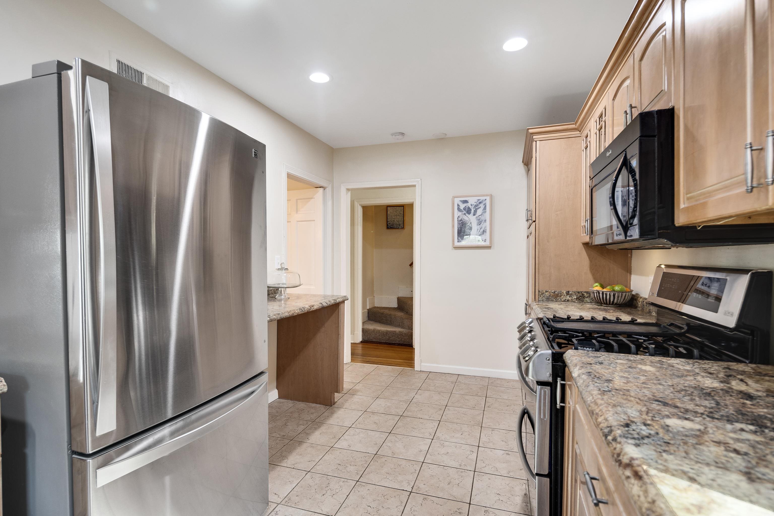 73 North Goodlett Street Memphis, TN 38117 - Photo 15 of 36 a kitchen with stainless steel appliances granite countertop a refrigerator and a stove top oven