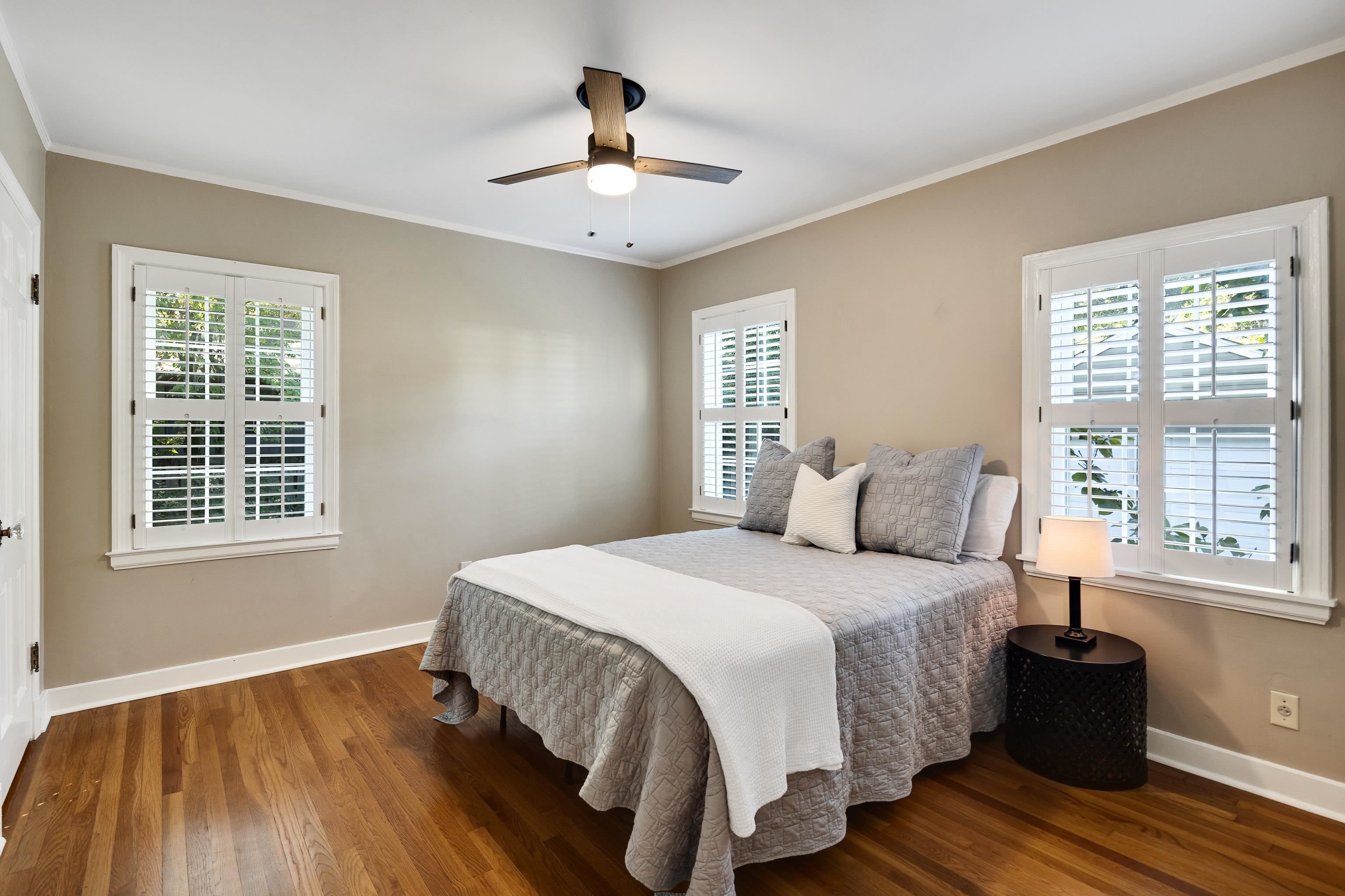 73 North Goodlett Street Memphis, TN 38117 - Photo 17 of 36 a bedroom with a large bed and wooden floor