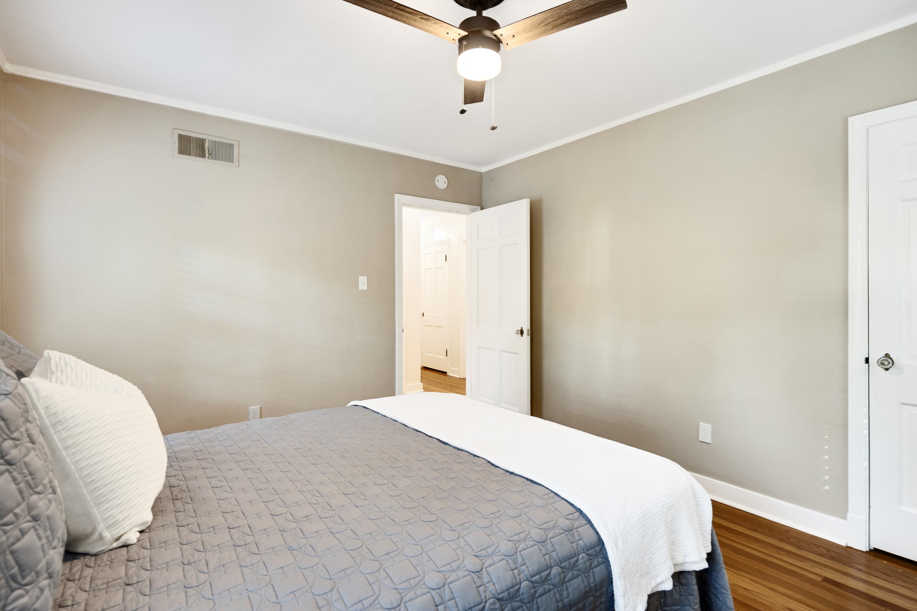 73 North Goodlett Street Memphis, TN 38117 - Photo 18 of 36 a bedroom with a bed and a chandelier