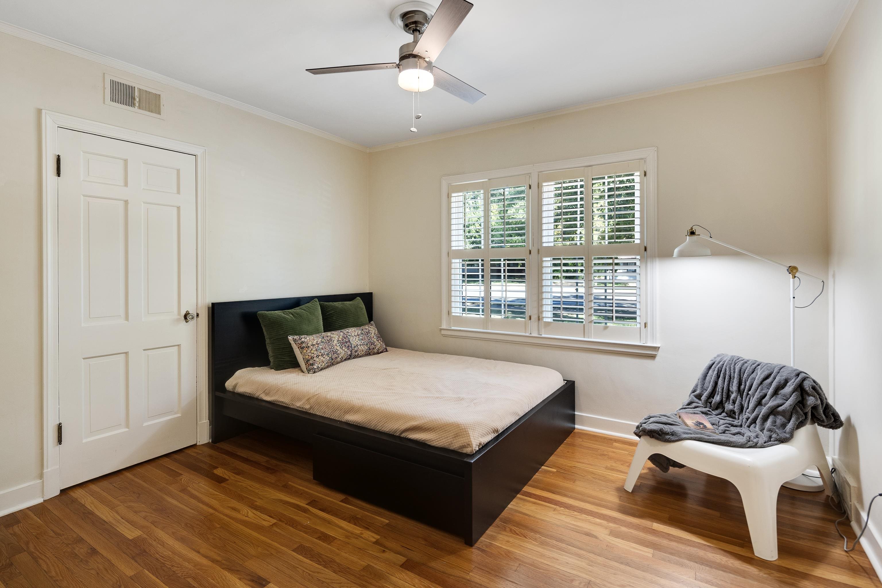 73 North Goodlett Street Memphis, TN 38117 - Photo 19 of 36 a bedroom with a bed and wooden floor