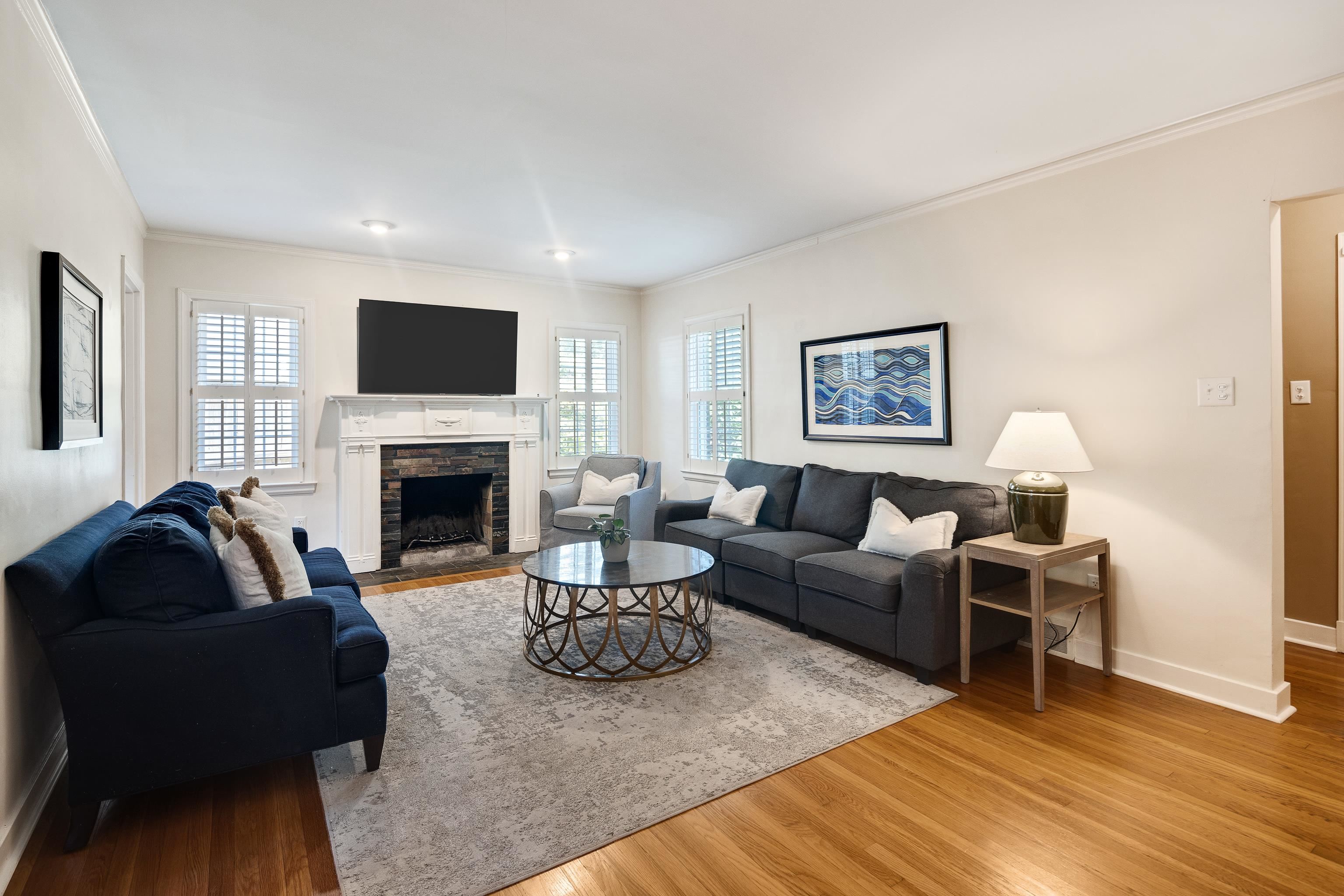 73 North Goodlett Street Memphis, TN 38117 - Photo 6 of 36 a living room with furniture a fireplace a flat screen tv and a window