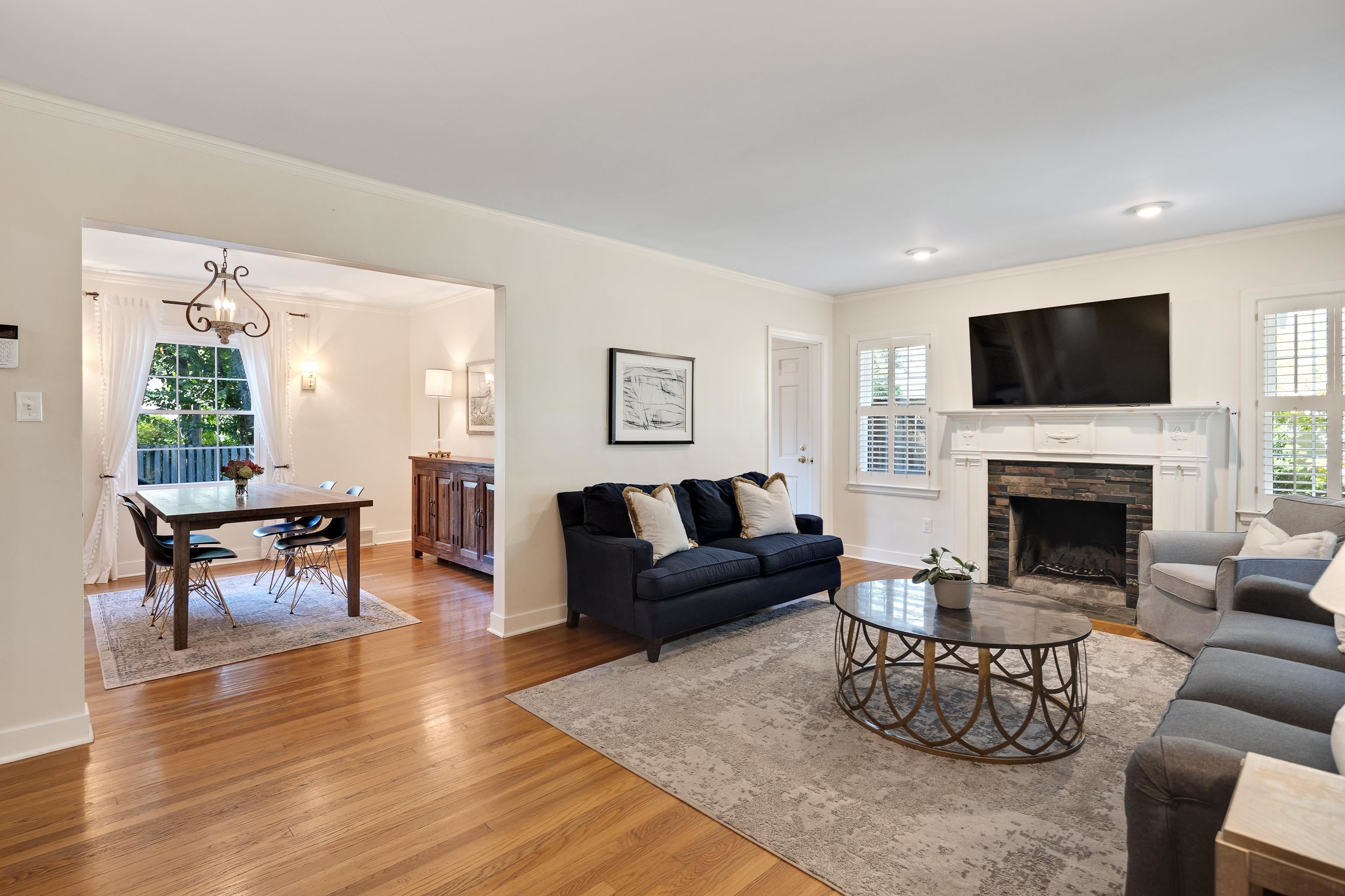 73 North Goodlett Street Memphis, TN 38117 - Photo 9 of 36 a living room with furniture a fireplace and a flat screen tv