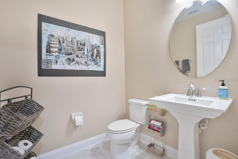 805 Riviera Bella Drive DeBary, FL 32713 - Photo 16 of 86 a bathroom with a toilet a sink and mirror