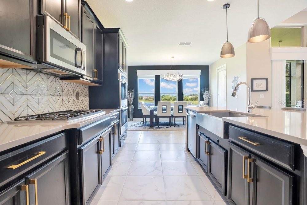 805 Riviera Bella Drive DeBary, FL 32713 - Photo 19 of 86 a kitchen with sink stove and cabinets