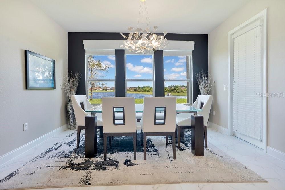 805 Riviera Bella Drive DeBary, FL 32713 - Photo 20 of 86 a view of a dining room with furniture wooden floor and chandelier
