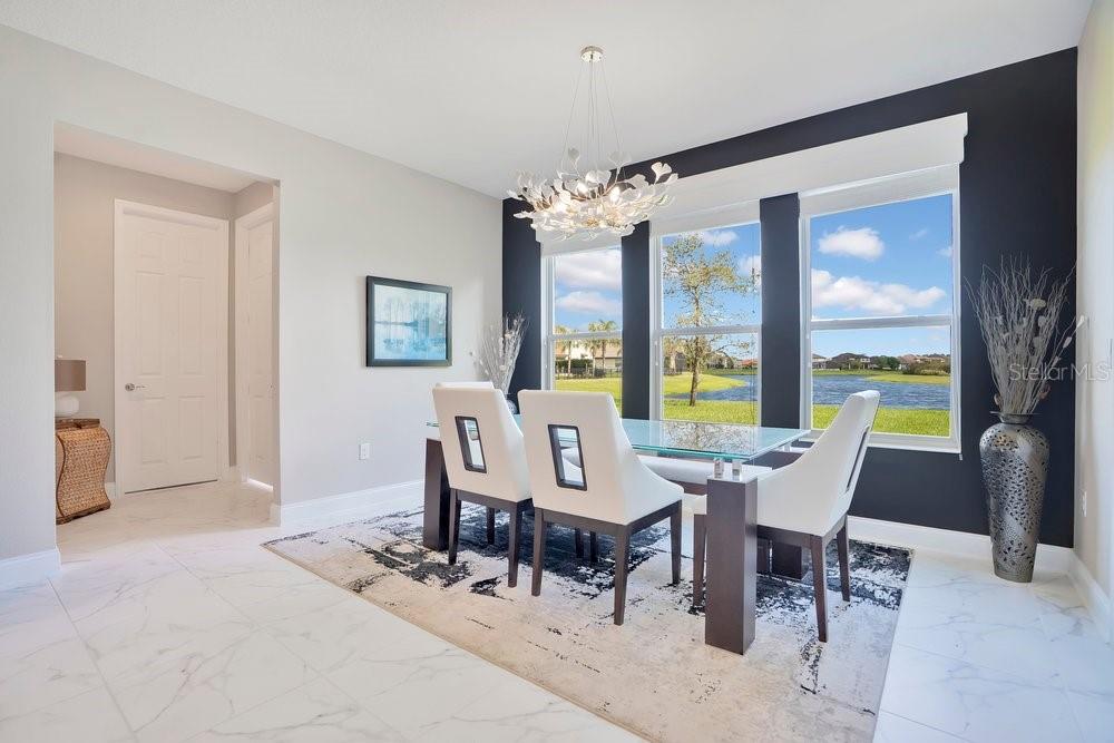805 Riviera Bella Drive DeBary, FL 32713 - Photo 21 of 86 a view of a dining room with furniture large windows and wooden floor