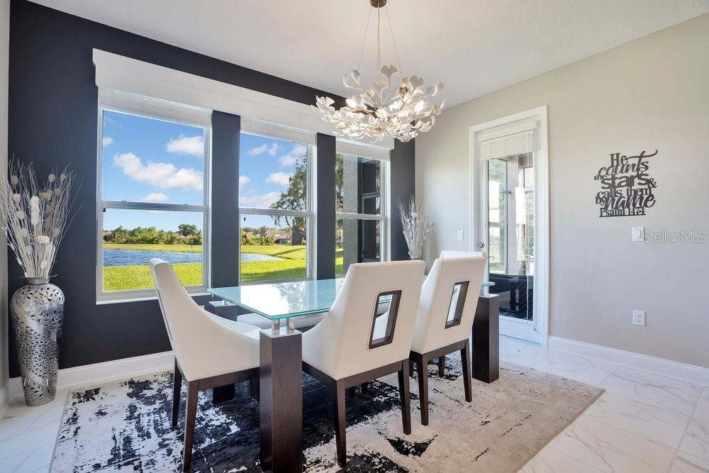 805 Riviera Bella Drive DeBary, FL 32713 - Photo 23 of 86 a view of a dining room with furniture a chandelier and wooden floor