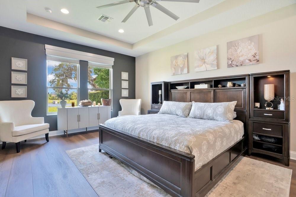 805 Riviera Bella Drive DeBary, FL 32713 - Photo 34 of 86 a spacious bedroom with a bed a couch and a large window