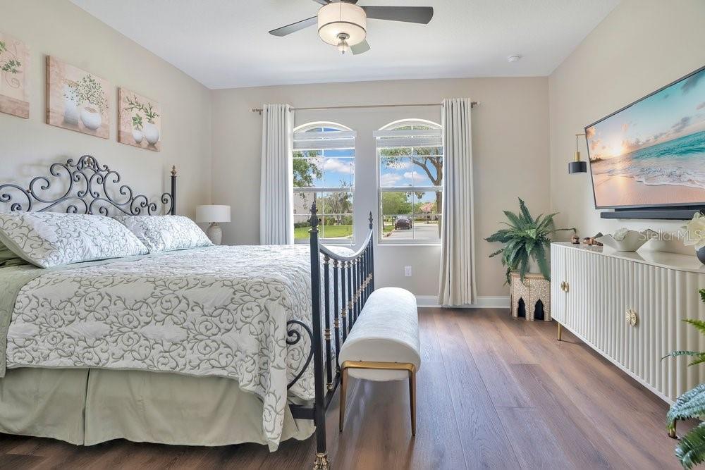 805 Riviera Bella Drive DeBary, FL 32713 - Photo 42 of 86 a bedroom with a balcony a bed and a flat screen tv