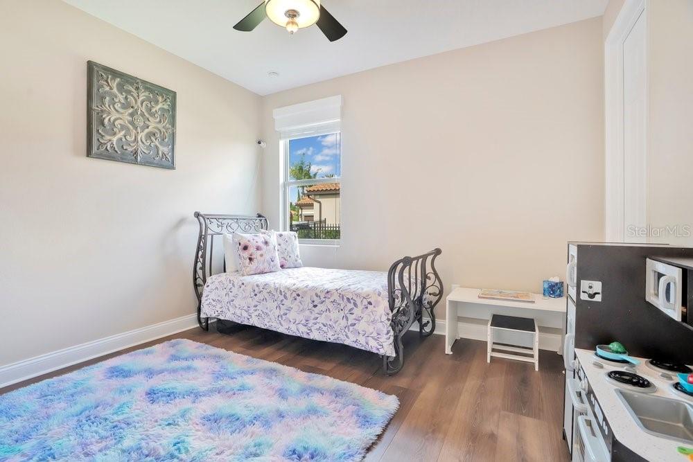 805 Riviera Bella Drive DeBary, FL 32713 - Photo 48 of 86 a bedroom with a bed and a desk