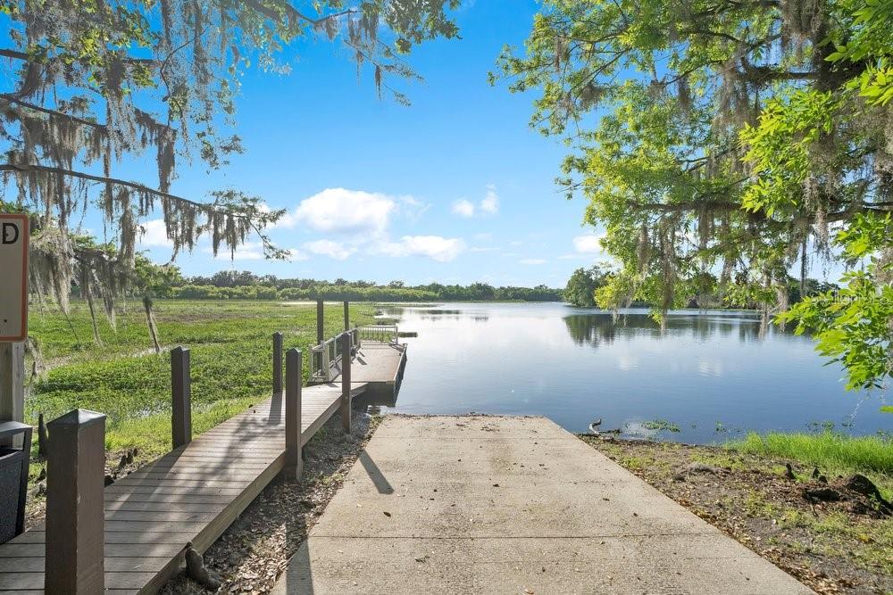 805 Riviera Bella Drive DeBary, FL 32713 - Photo 65 of 86 a view of a lake with a big yard and potted plants