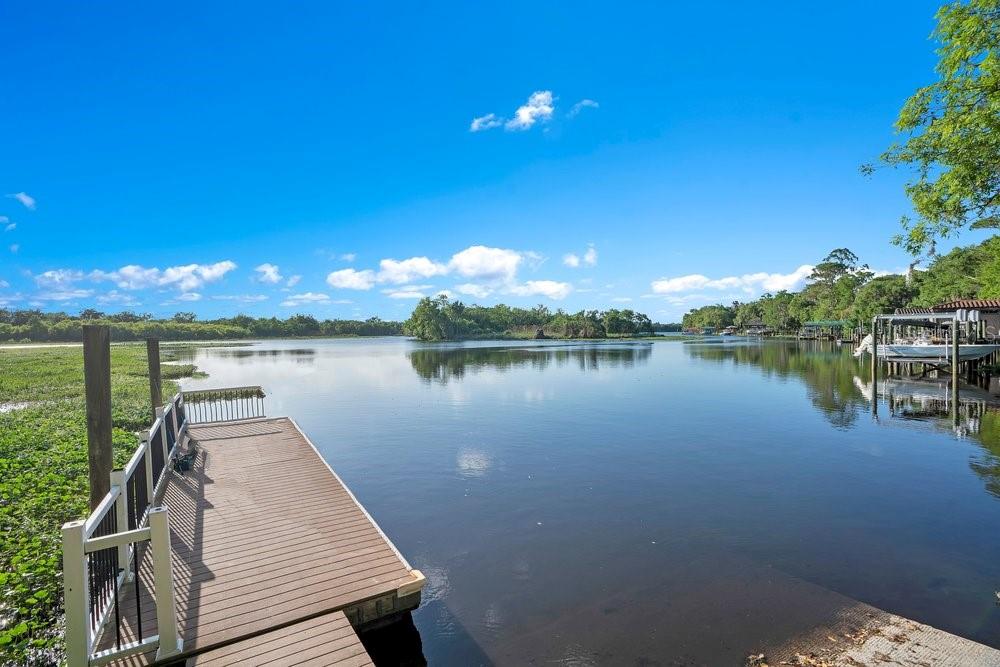 805 Riviera Bella Drive DeBary, FL 32713 - Photo 66 of 86 a view of a lake with couches and wooden floor