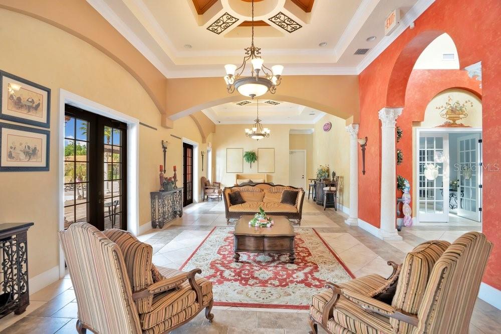 805 Riviera Bella Drive DeBary, FL 32713 - Photo 69 of 86 a living room with furniture a chandelier and a large window