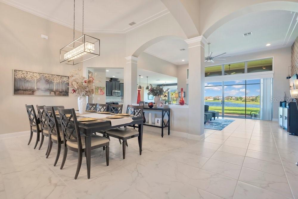 805 Riviera Bella Drive DeBary, FL 32713 - Photo 10 of 86 a view of a dining room with furniture and a large window