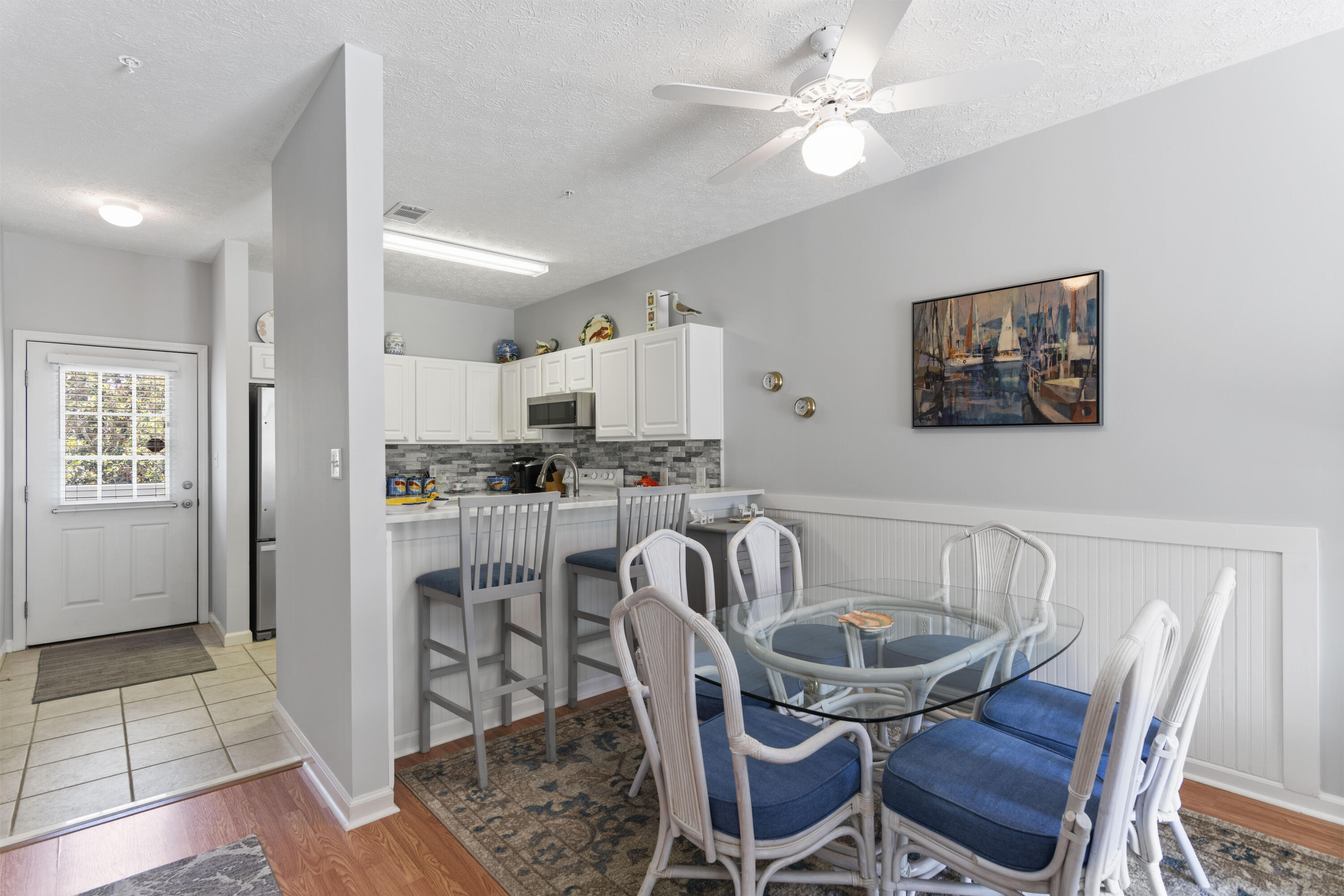 34 Heron's Watch Way, Unit 2202 Santa Rosa Beach, FL 32459 - Photo 12 of 29 a kitchen with granite countertop a dining table chairs and a refrigerator