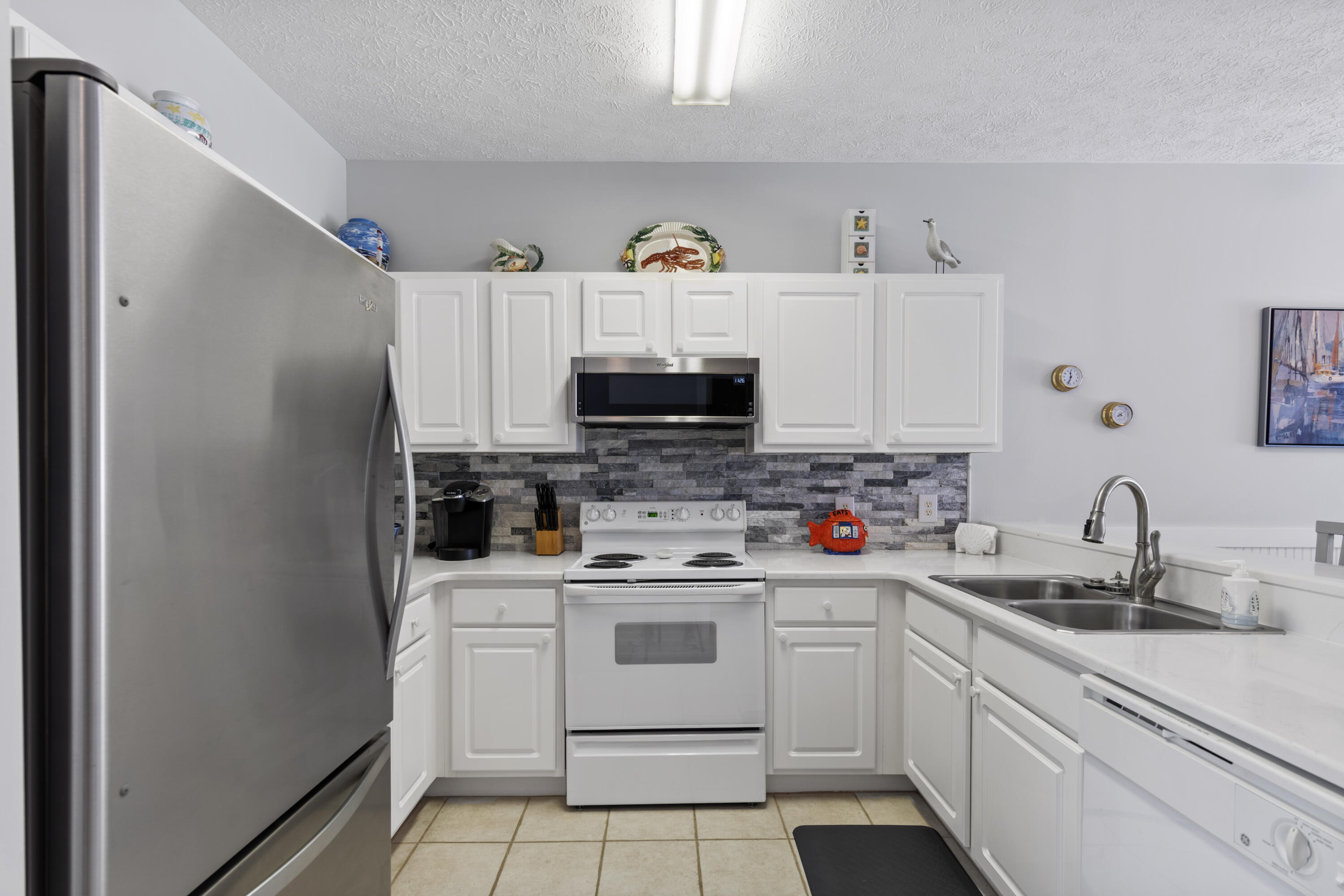 34 Heron's Watch Way, Unit 2202 Santa Rosa Beach, FL 32459 - Photo 13 of 29 a kitchen with stainless steel appliances white cabinets and a sink