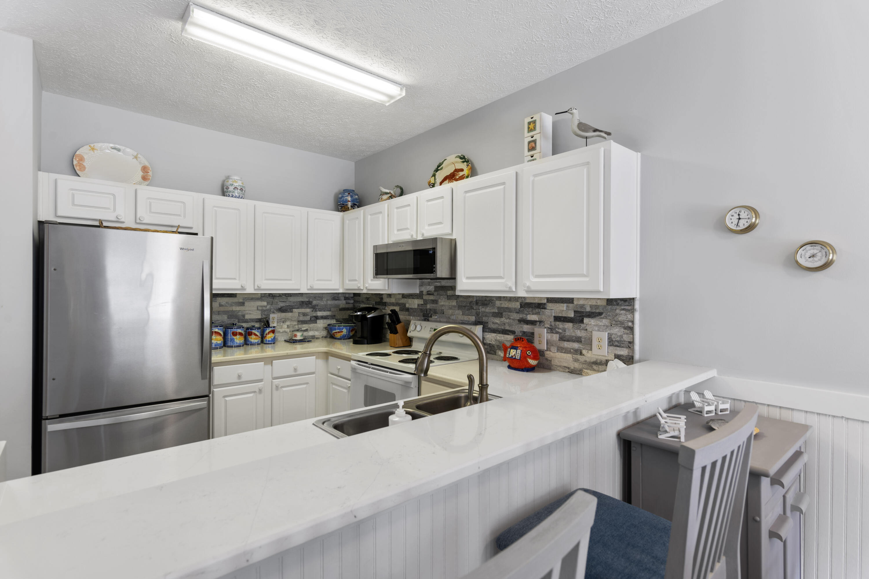 34 Heron's Watch Way, Unit 2202 Santa Rosa Beach, FL 32459 - Photo 15 of 29 a kitchen with stainless steel appliances a refrigerator stove microwave and sink