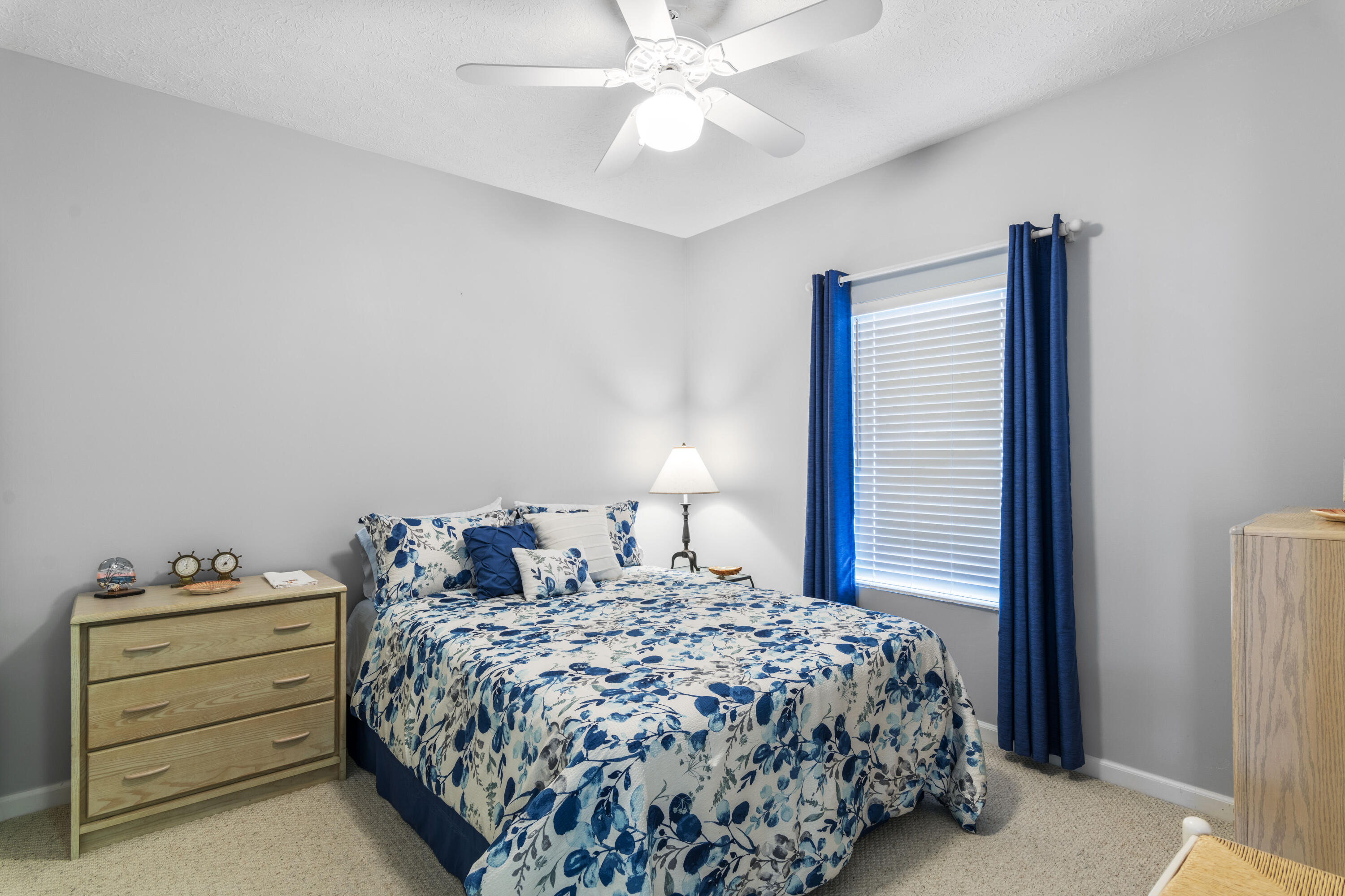 34 Heron's Watch Way, Unit 2202 Santa Rosa Beach, FL 32459 - Photo 20 of 29 a bedroom with a bed and a chandelier