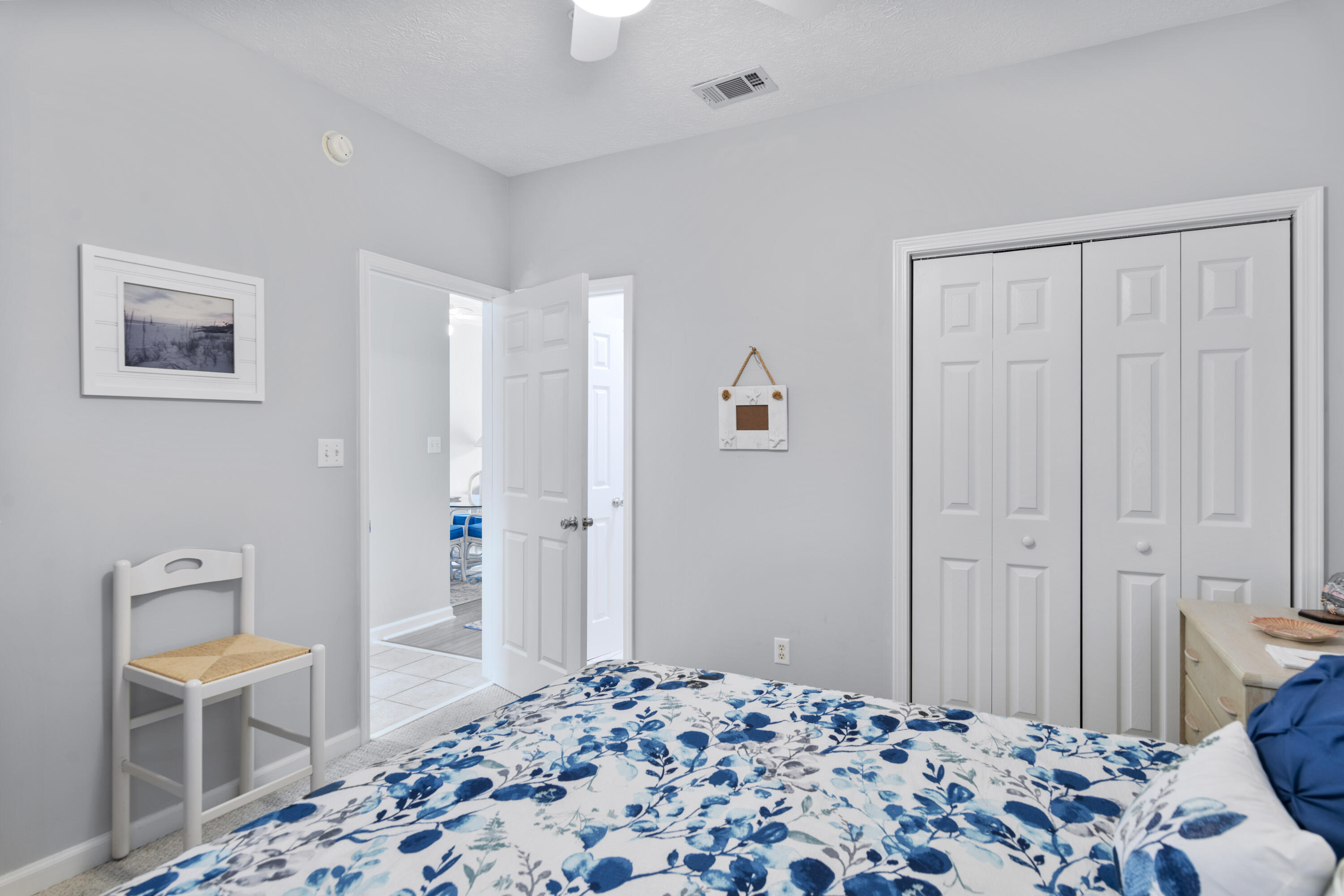 34 Heron's Watch Way, Unit 2202 Santa Rosa Beach, FL 32459 - Photo 21 of 29 a bedroom with a bed and wooden floor