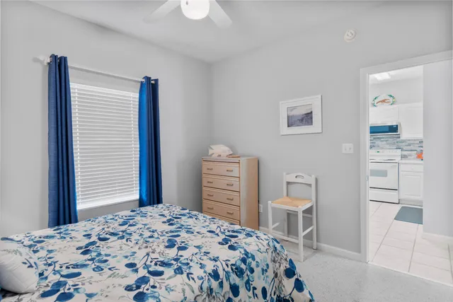 a bedroom with a bed and a chair with the view of a bedroom