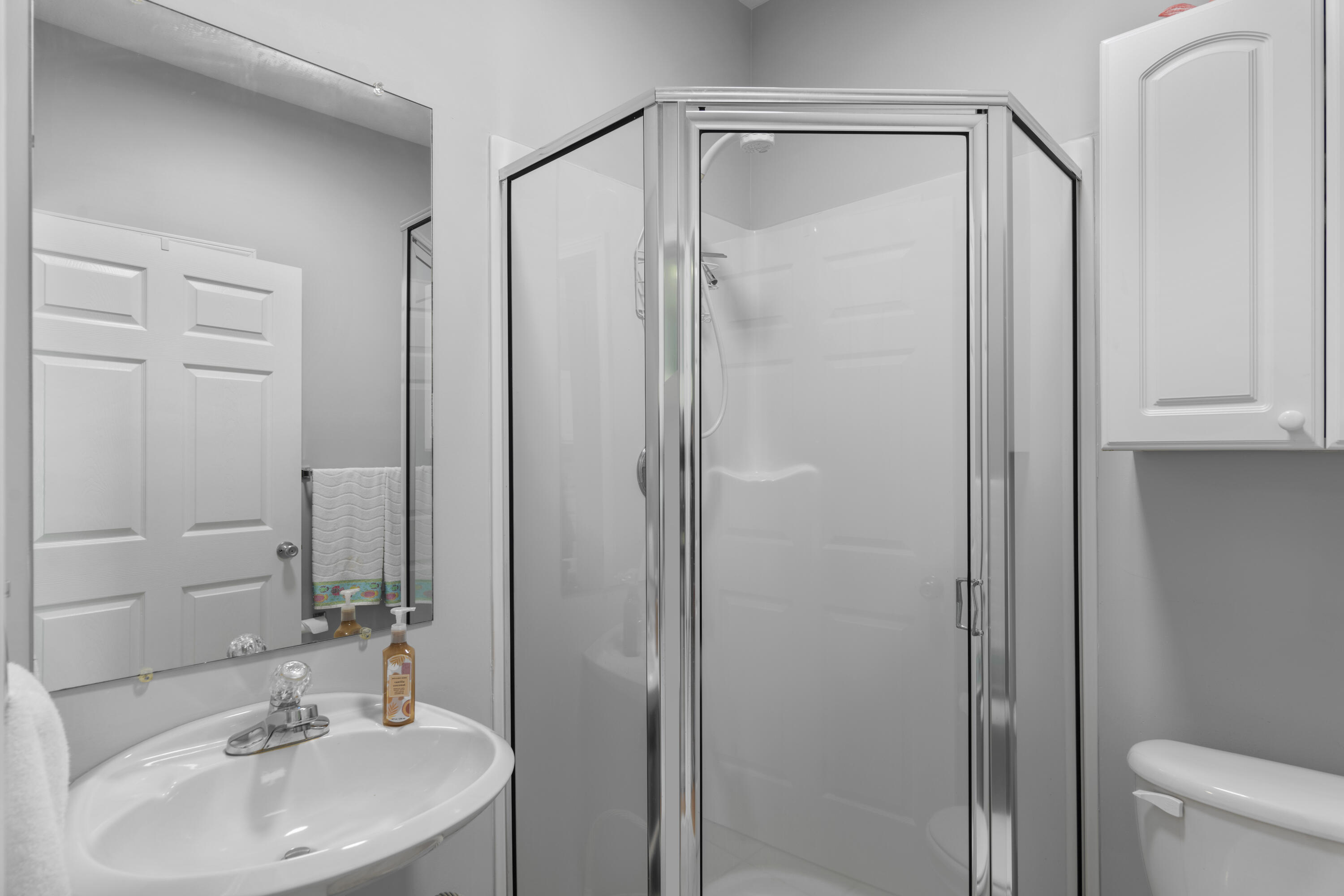 34 Heron's Watch Way, Unit 2202 Santa Rosa Beach, FL 32459 - Photo 23 of 29 a bathroom with a sink a mirror a toilet and shower