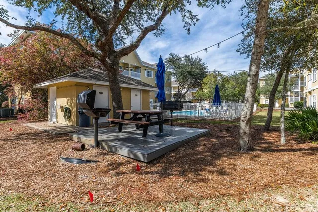 a view of a house with backyard porch and sitting area