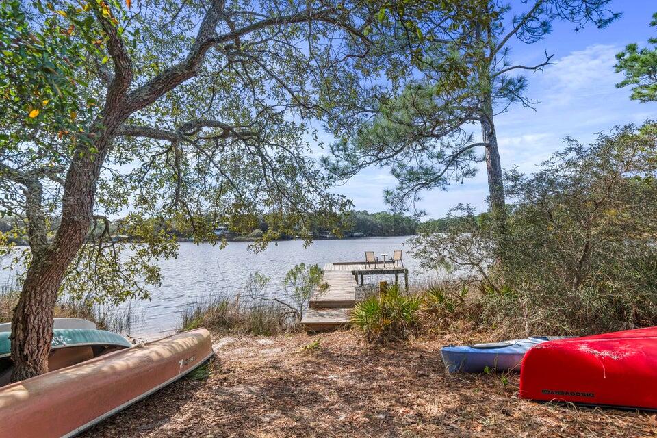 34 Heron's Watch Way, Unit 2202 Santa Rosa Beach, FL 32459 - Photo 26 of 29 a view of a backyard with table and chairs potted plants and large tree
