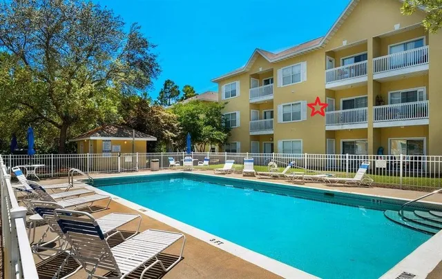 a front view of a house with swimming pool and porch