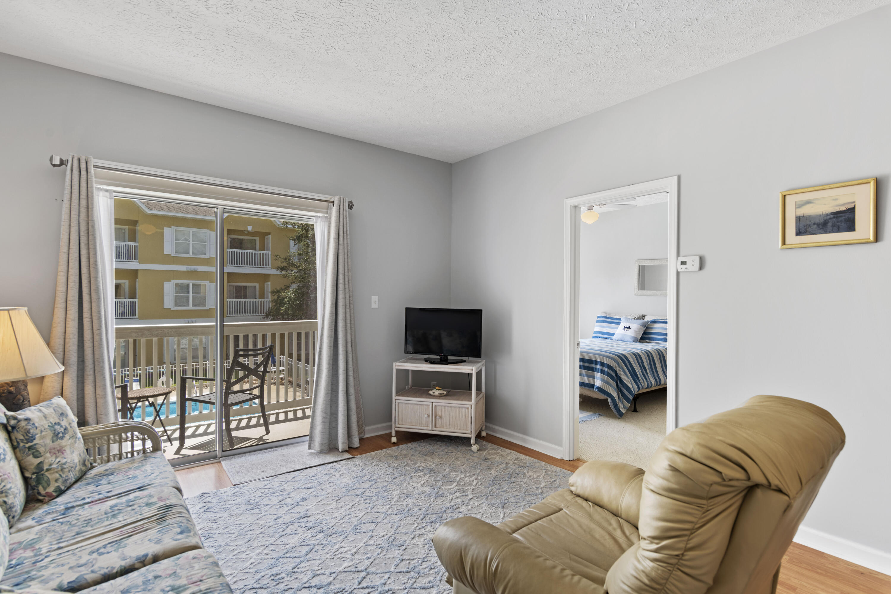 34 Heron's Watch Way, Unit 2202 Santa Rosa Beach, FL 32459 - Photo 6 of 29 a living room with furniture and a flat screen tv