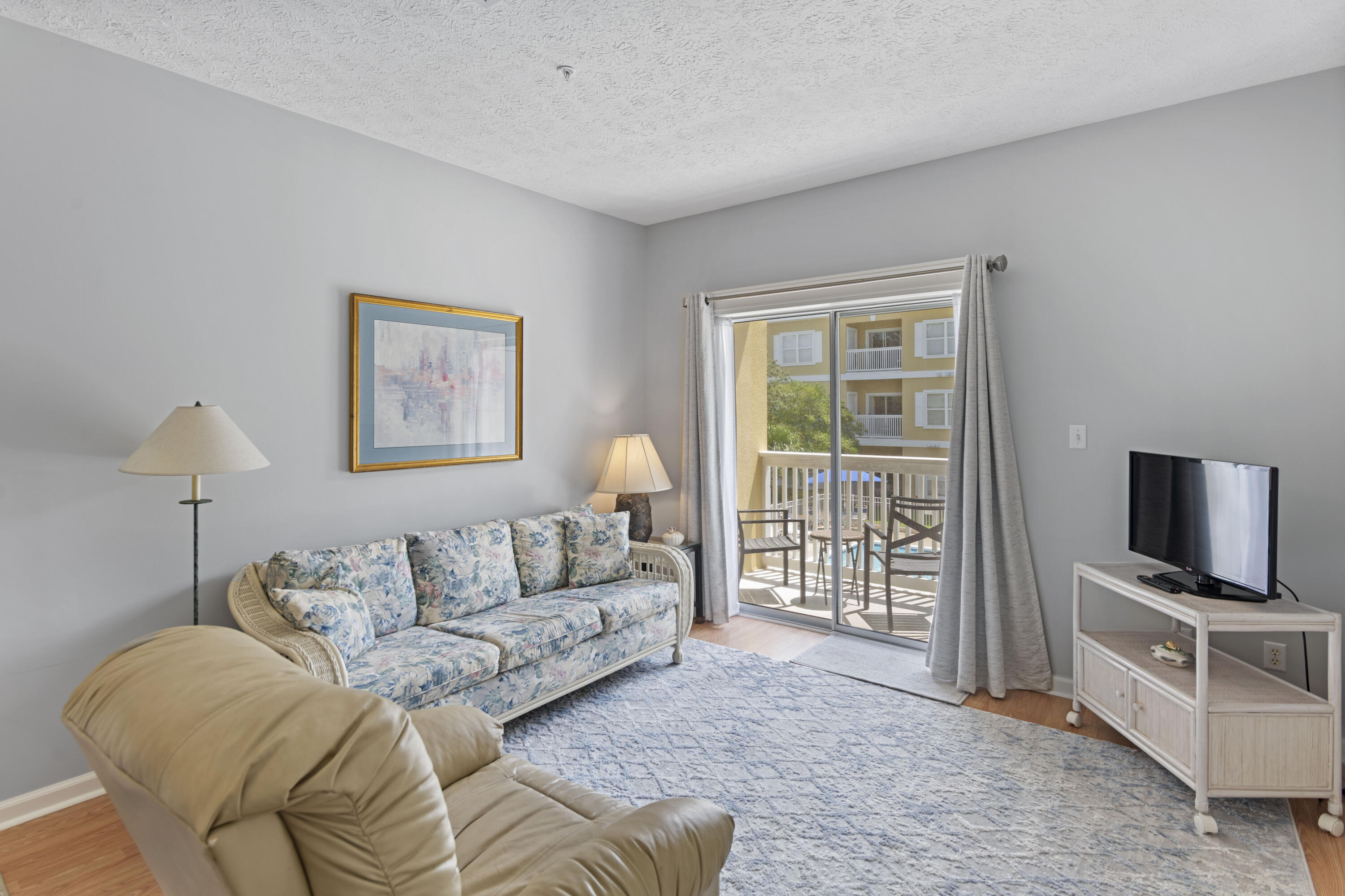 34 Heron's Watch Way, Unit 2202 Santa Rosa Beach, FL 32459 - Photo 7 of 29 a living room with furniture a flat screen tv and a window