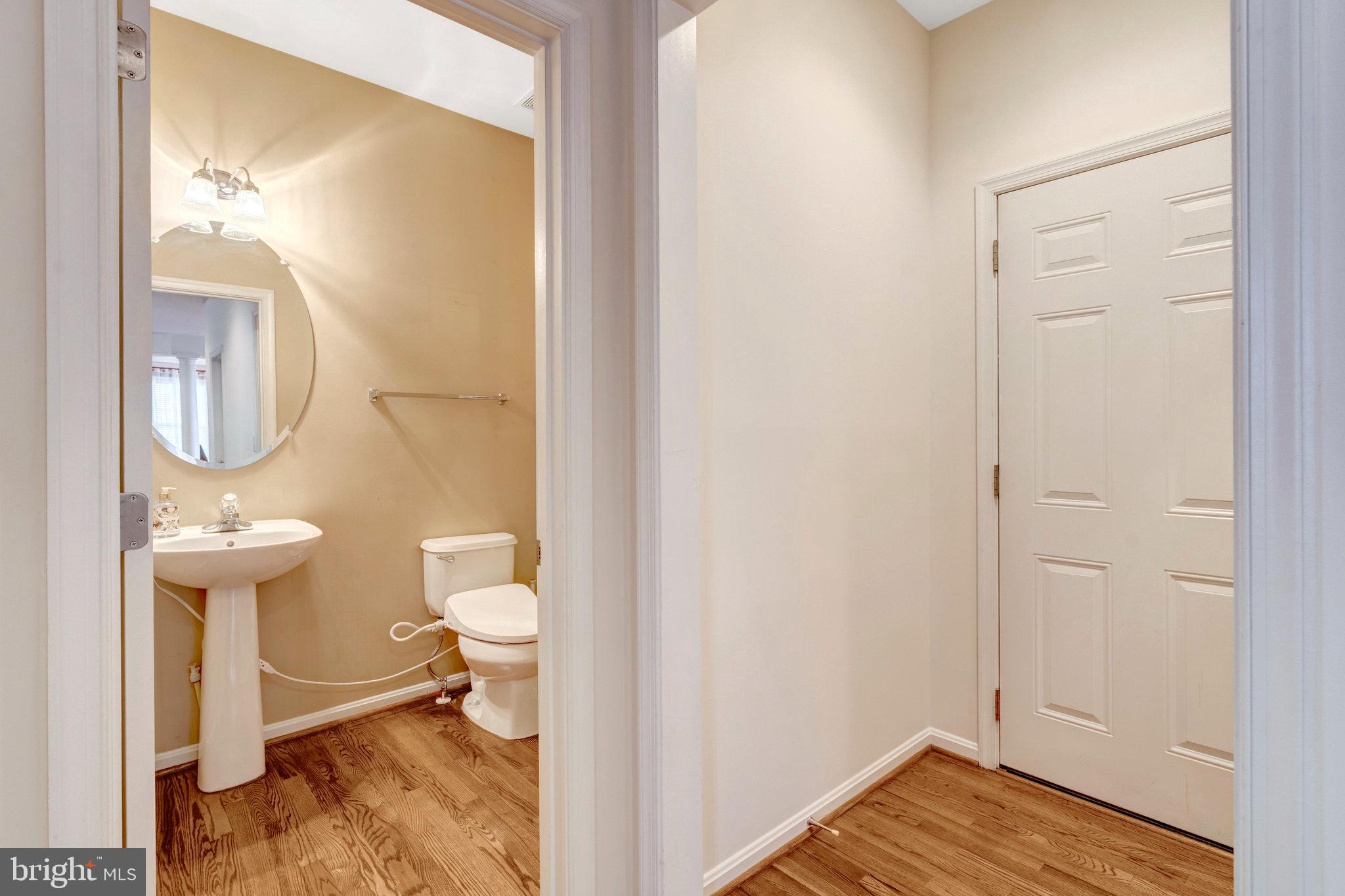 7726 Yalta Way Gainesville, VA 20155 - Photo 11 of 75 a view of bathroom with a toilet a sink and a mirror