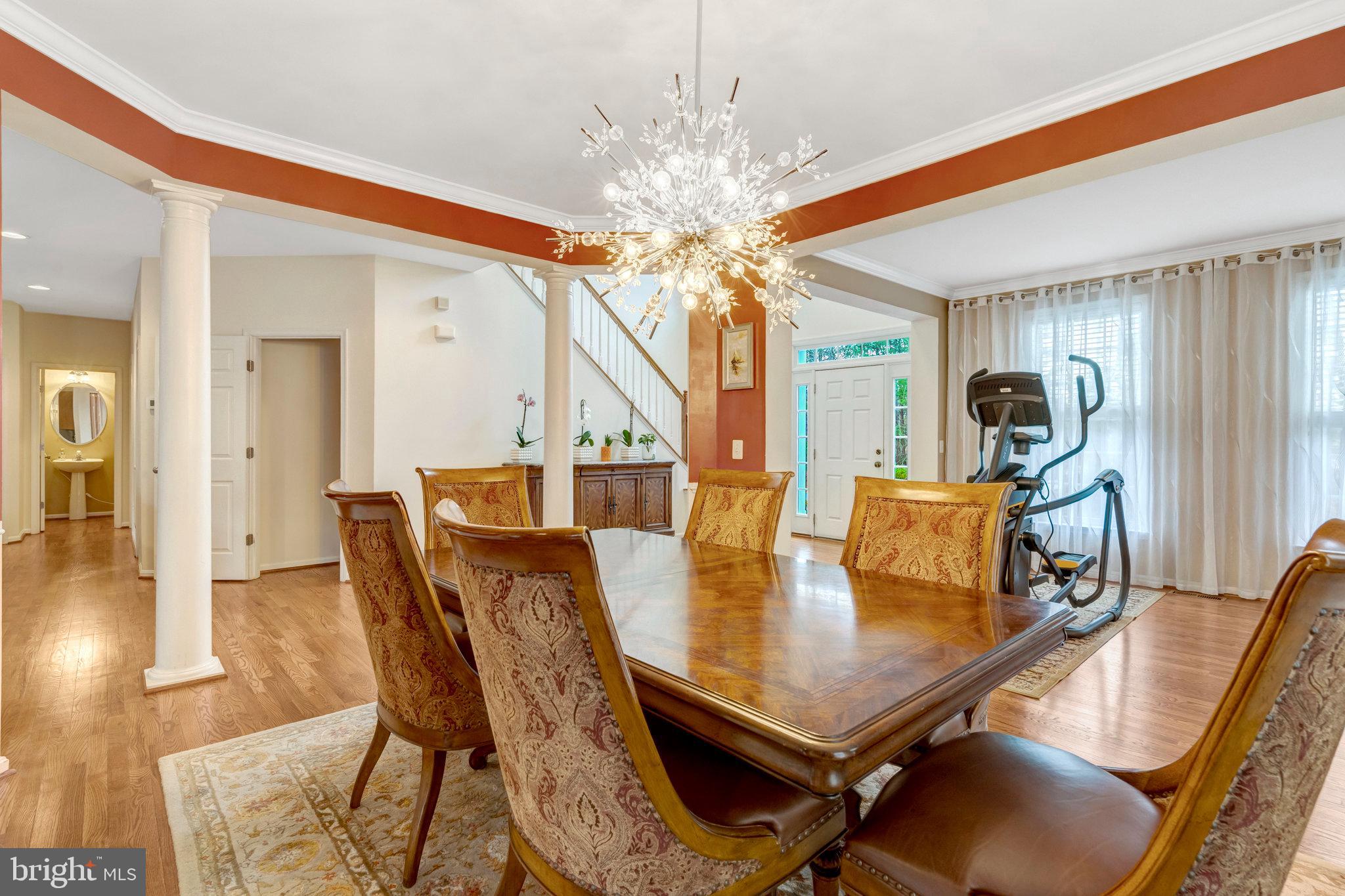 7726 Yalta Way Gainesville, VA 20155 - Photo 17 of 75 a view of a dining room with furniture and wooden floor