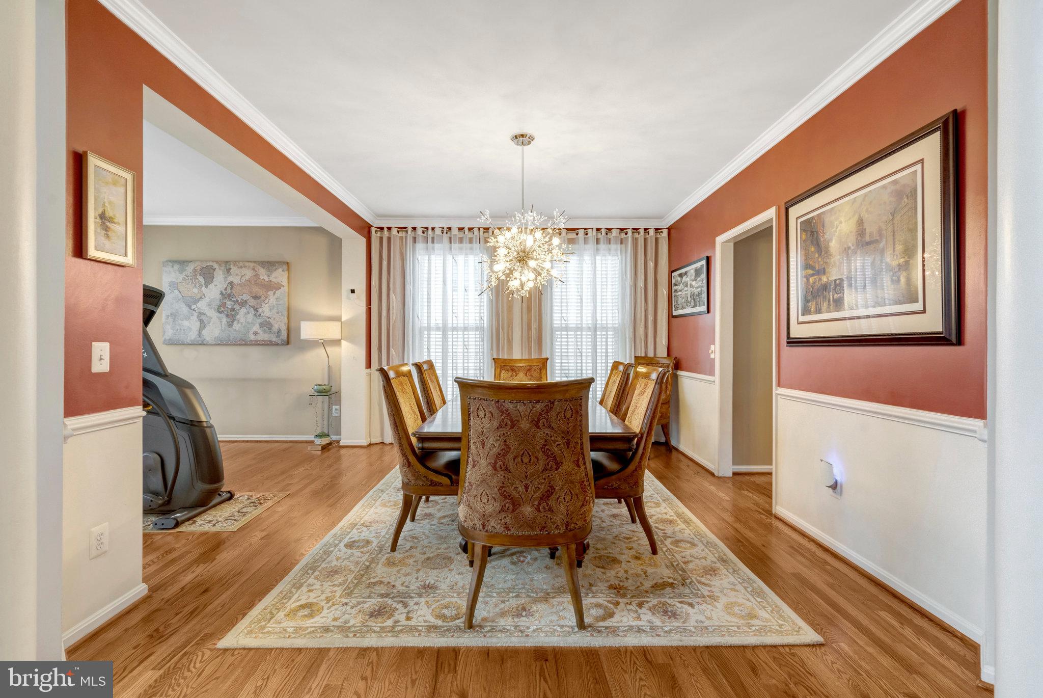 7726 Yalta Way Gainesville, VA 20155 - Photo 18 of 75 a dining room with furniture a rug and wooden floor