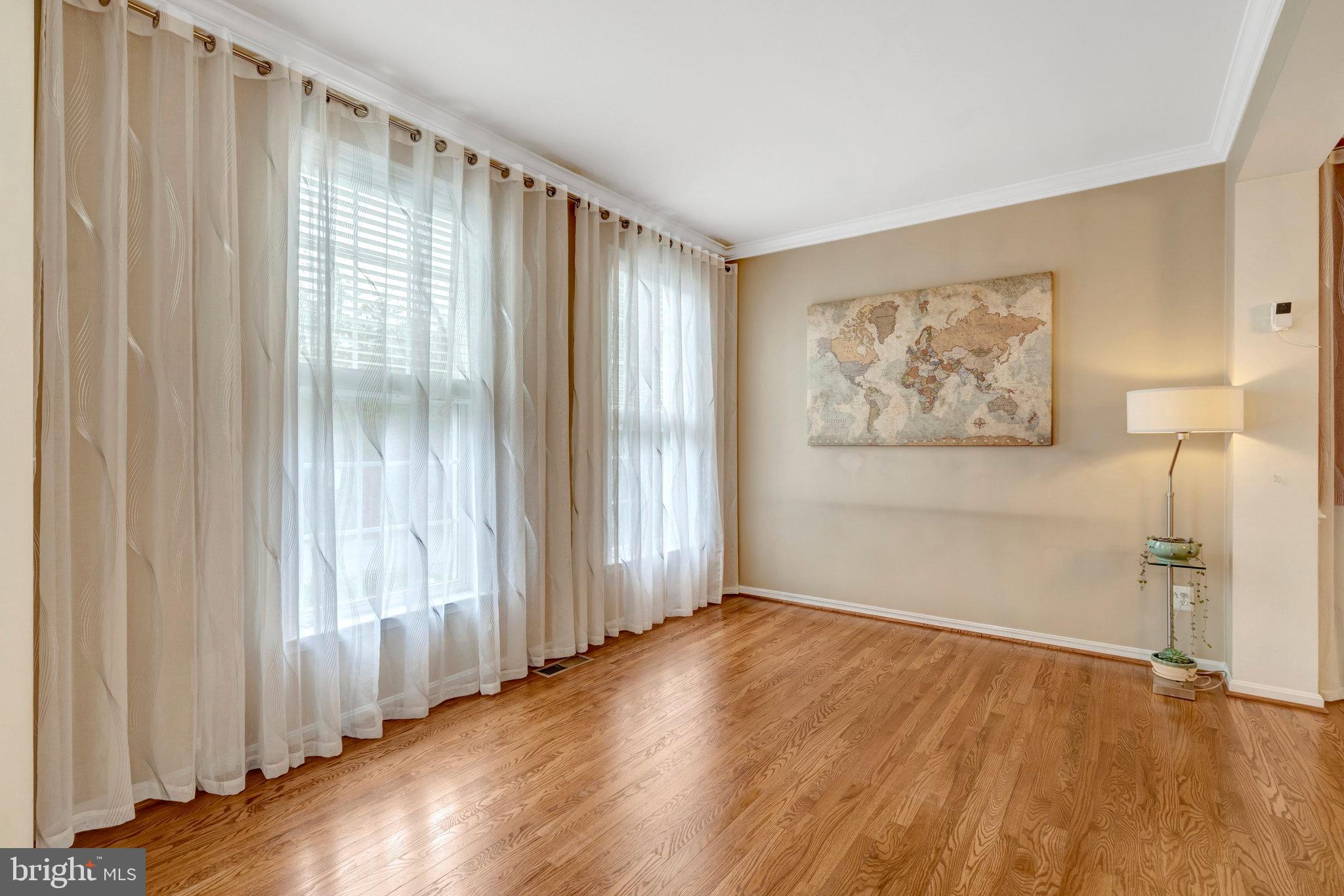 7726 Yalta Way Gainesville, VA 20155 - Photo 21 of 75 an empty room with wooden floor and a window