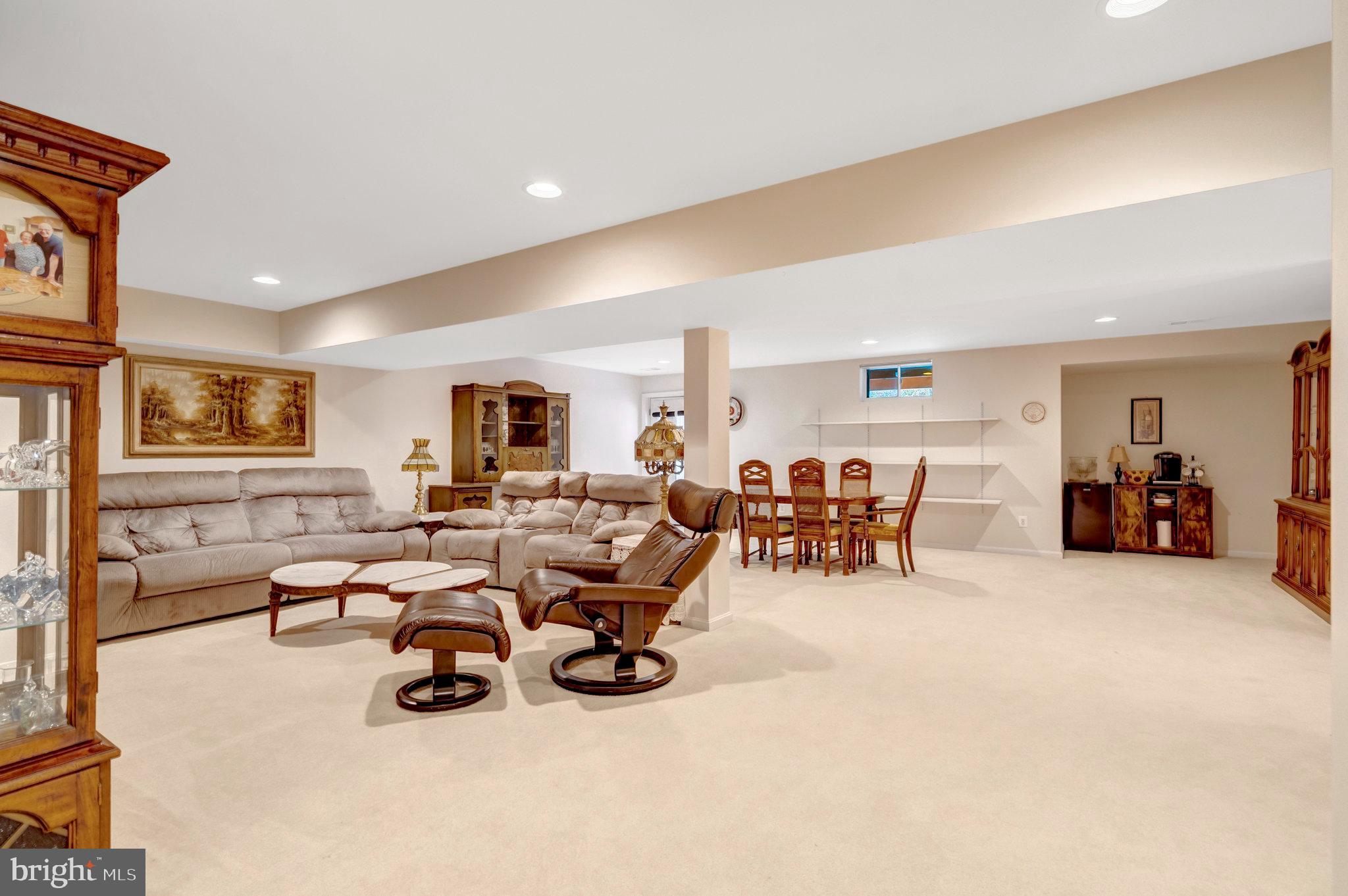 7726 Yalta Way Gainesville, VA 20155 - Photo 27 of 75 a living room with lots of furniture and a large window