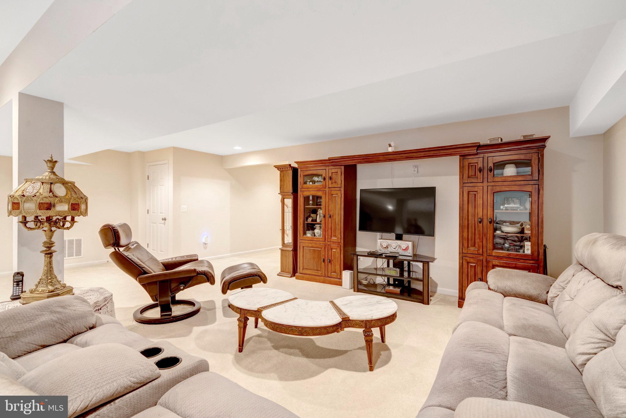 7726 Yalta Way Gainesville, VA 20155 - Photo 33 of 75 a living room with furniture and a flat screen tv