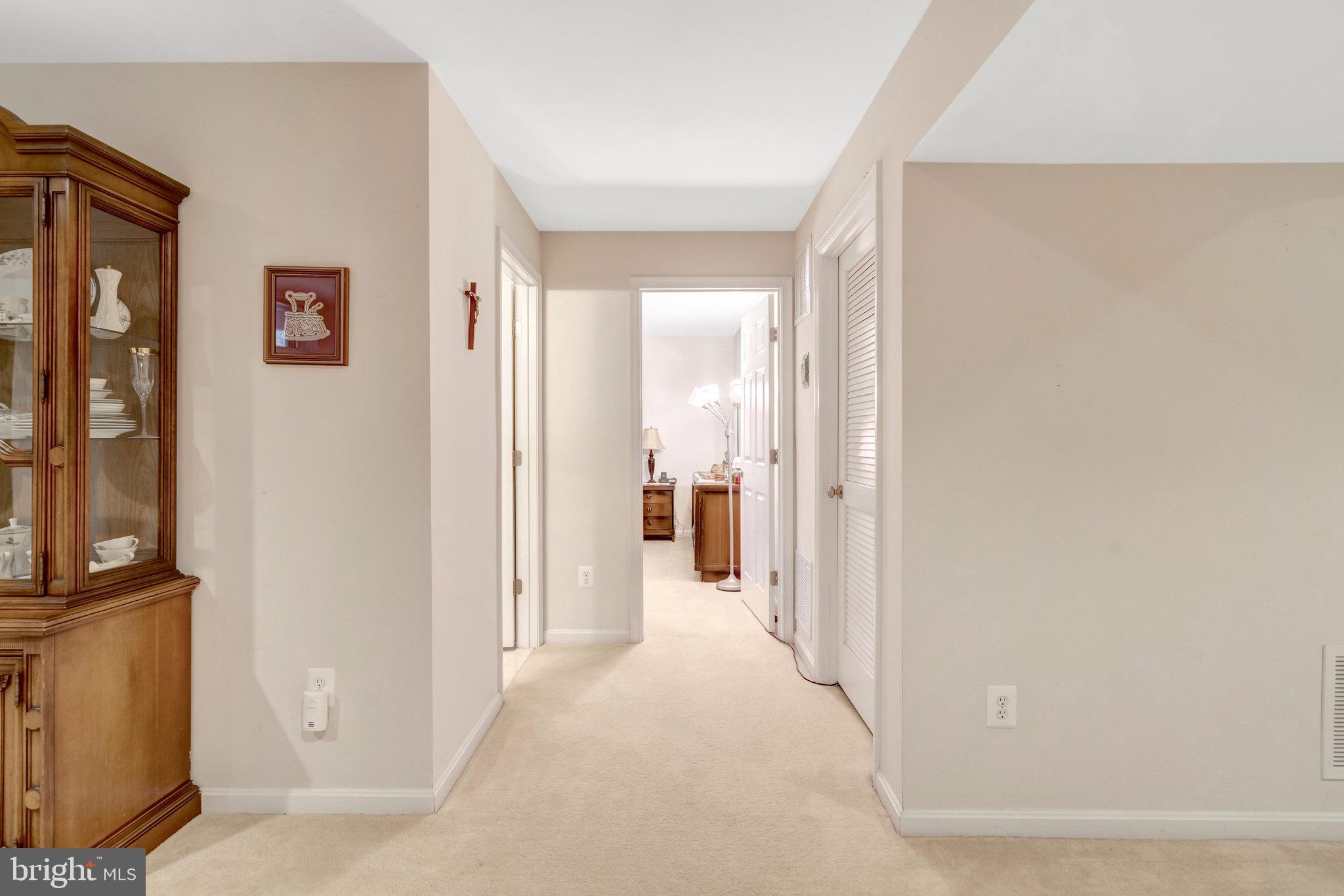 7726 Yalta Way Gainesville, VA 20155 - Photo 34 of 75 a view of a hallway with wooden floor and living room