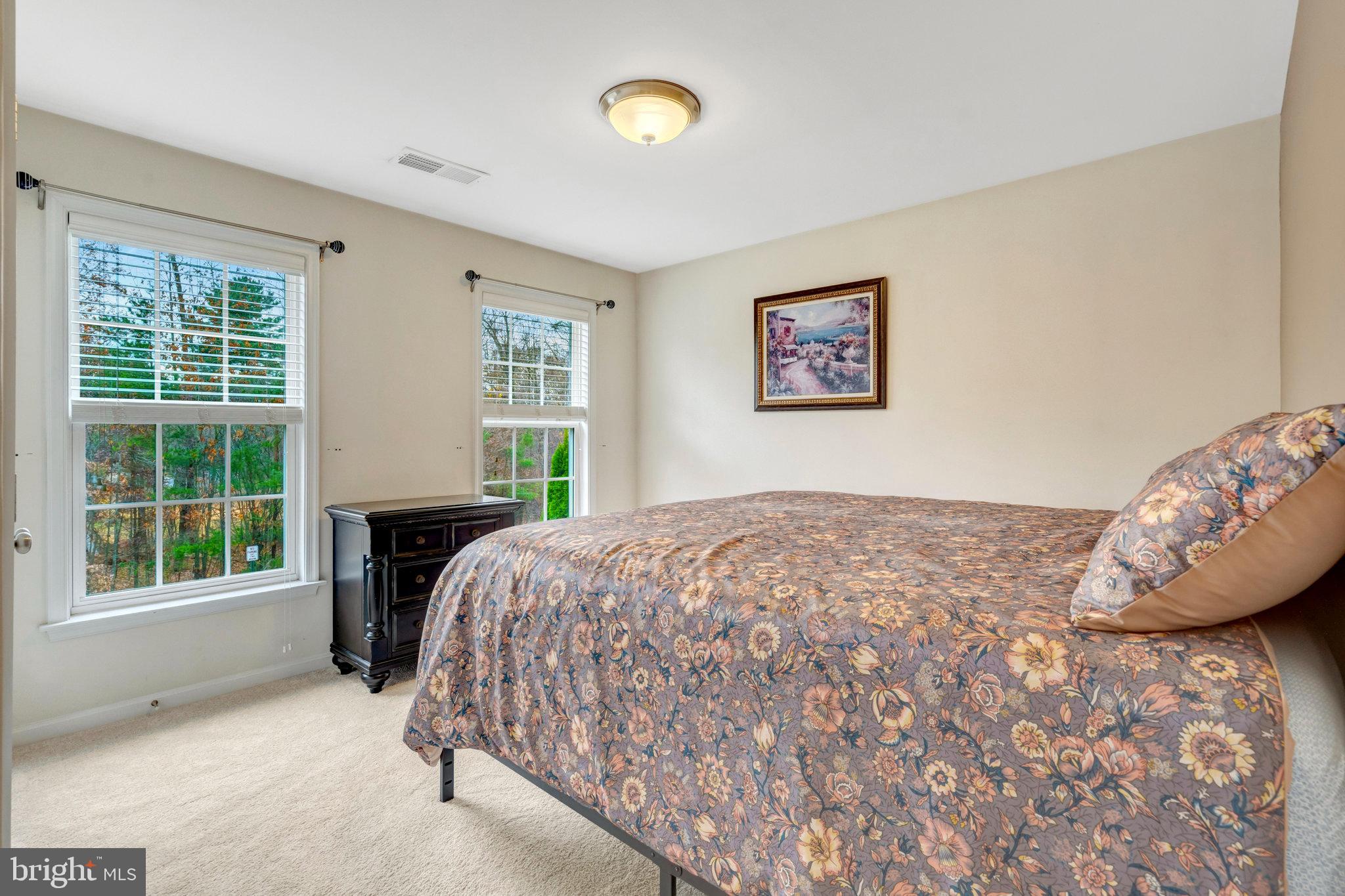 7726 Yalta Way Gainesville, VA 20155 - Photo 38 of 75 a bed sitting in a bedroom next to a window