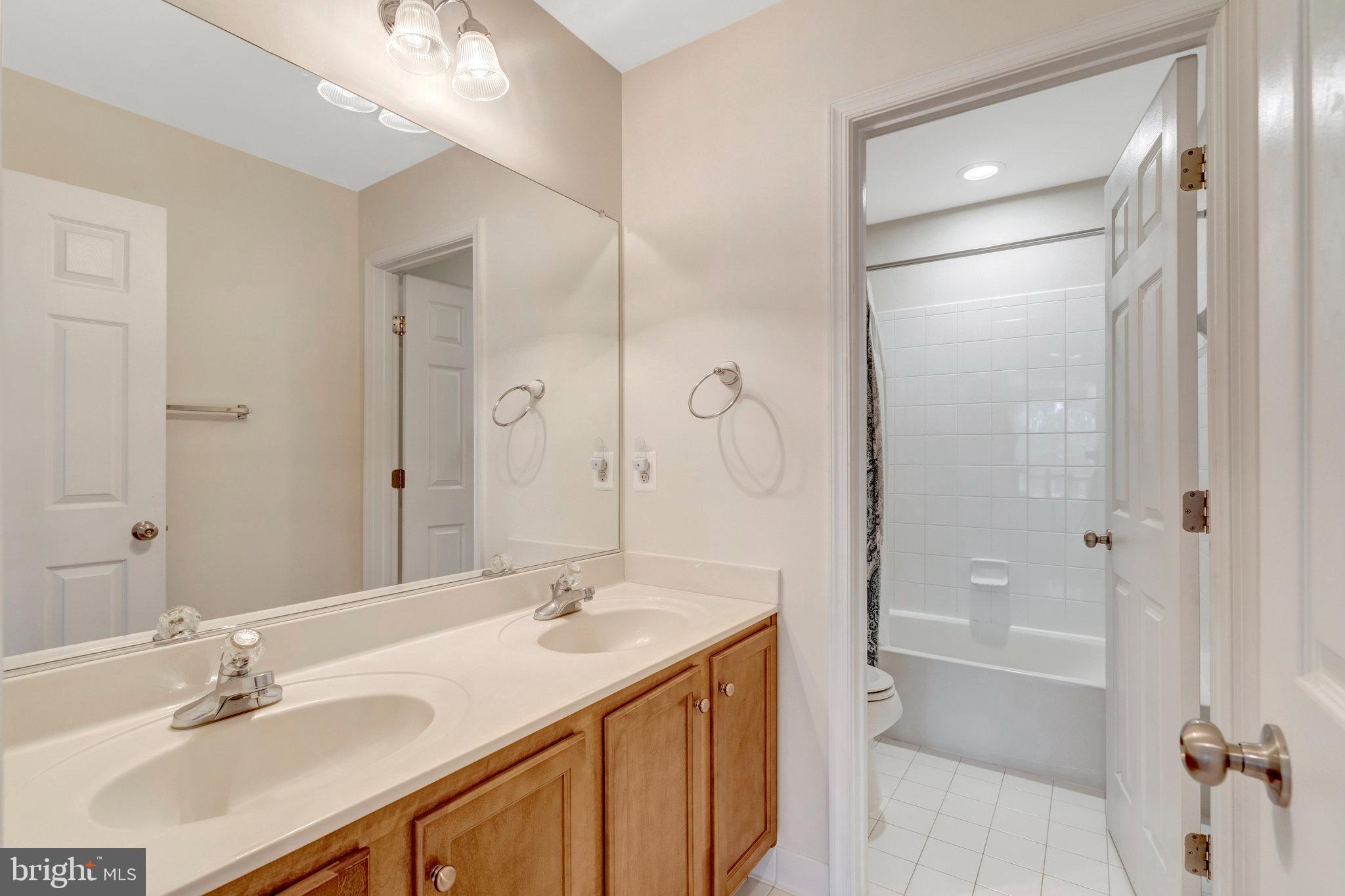7726 Yalta Way Gainesville, VA 20155 - Photo 42 of 75 a bathroom with a sink double vanity granite tub and shower
