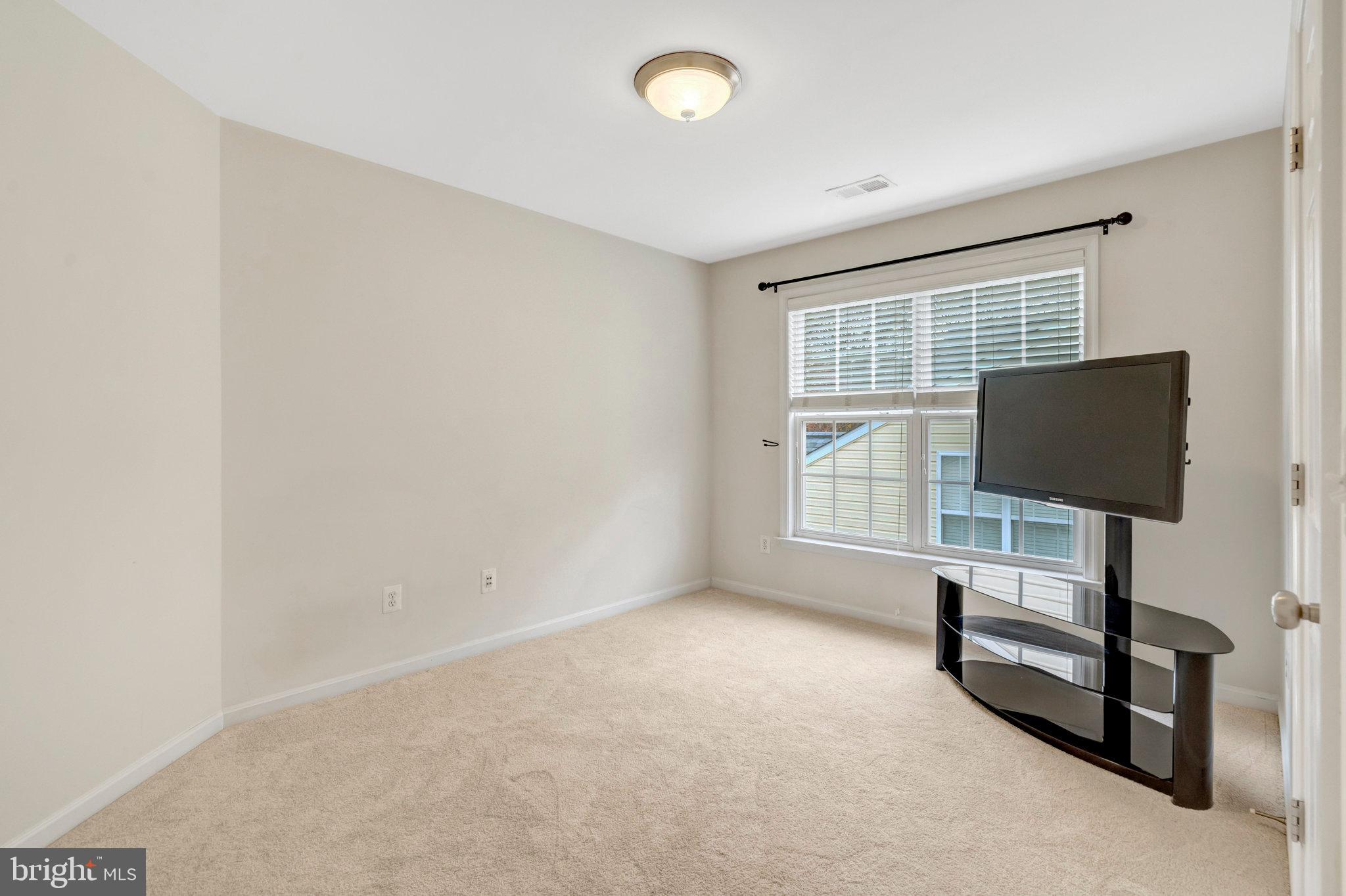 7726 Yalta Way Gainesville, VA 20155 - Photo 45 of 75 a living room with furniture and a flat screen tv