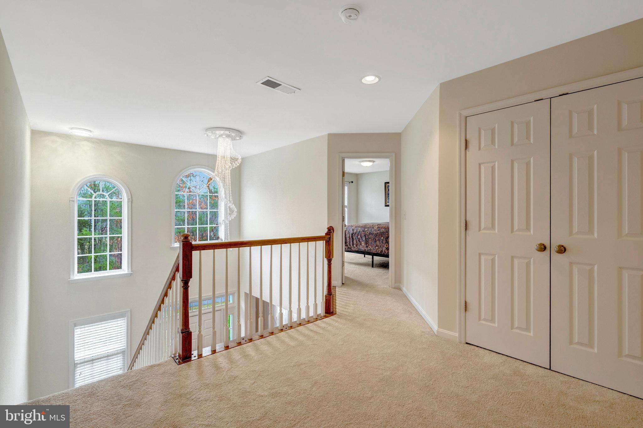 7726 Yalta Way Gainesville, VA 20155 - Photo 48 of 75 a view of a hallway with windows and stairs