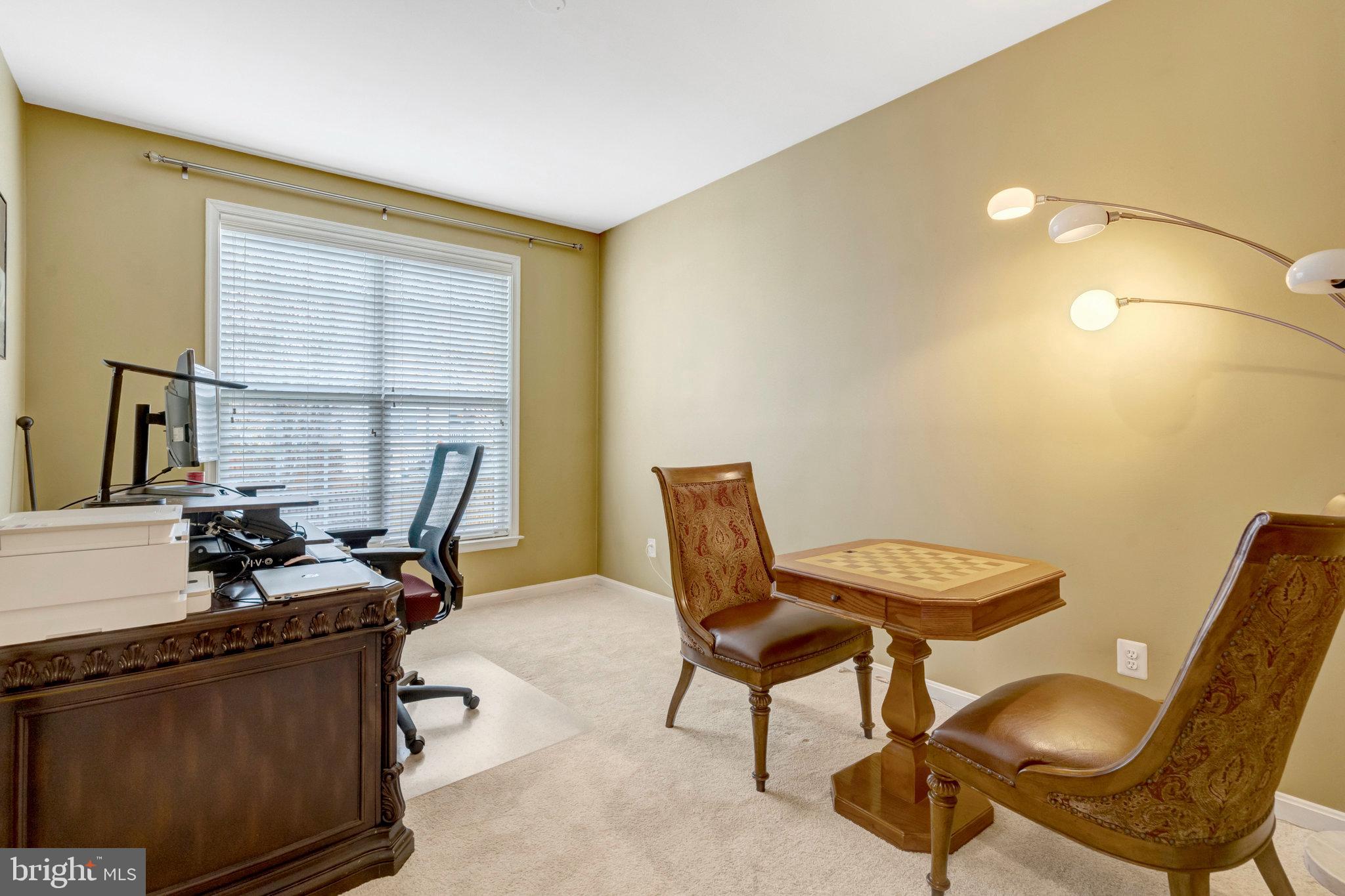7726 Yalta Way Gainesville, VA 20155 - Photo 59 of 75 a view of a workspace with furniture and a window