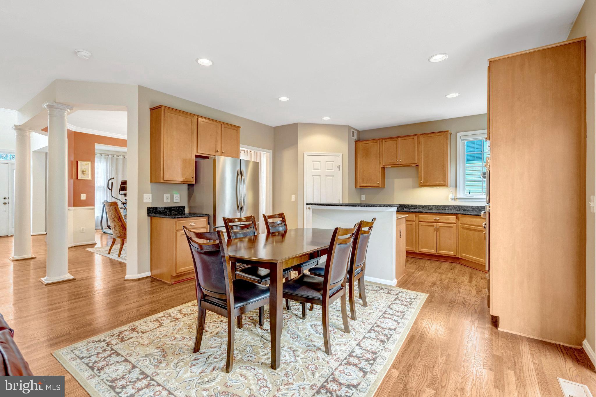 7726 Yalta Way Gainesville, VA 20155 - Photo 6 of 75 a view of a dining room with furniture and wooden floor