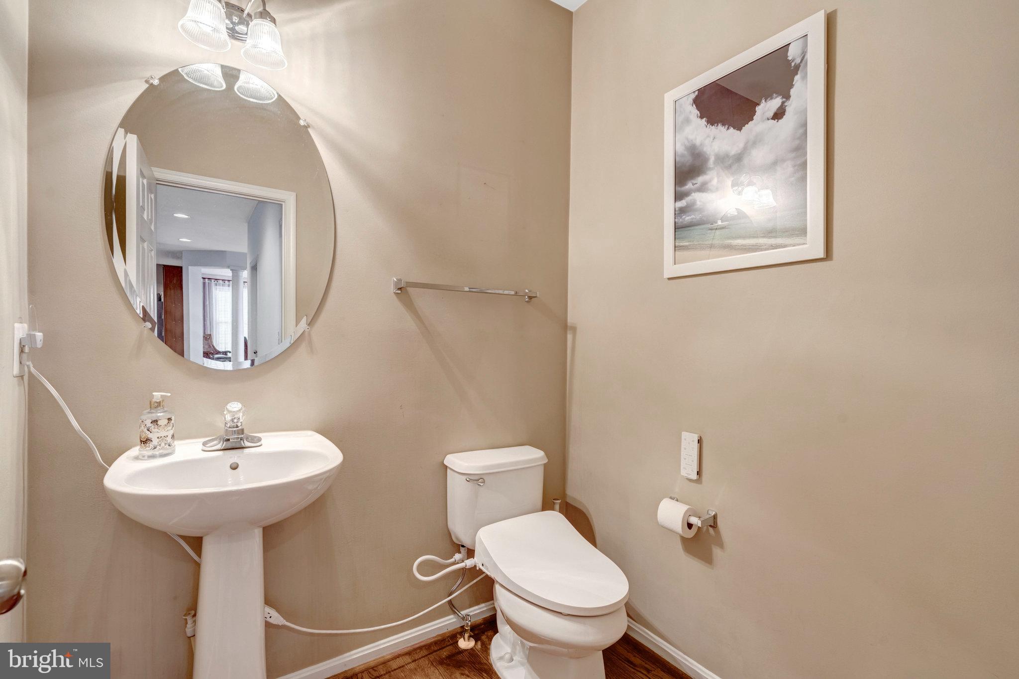 7726 Yalta Way Gainesville, VA 20155 - Photo 61 of 75 a bathroom with a toilet sink and mirror