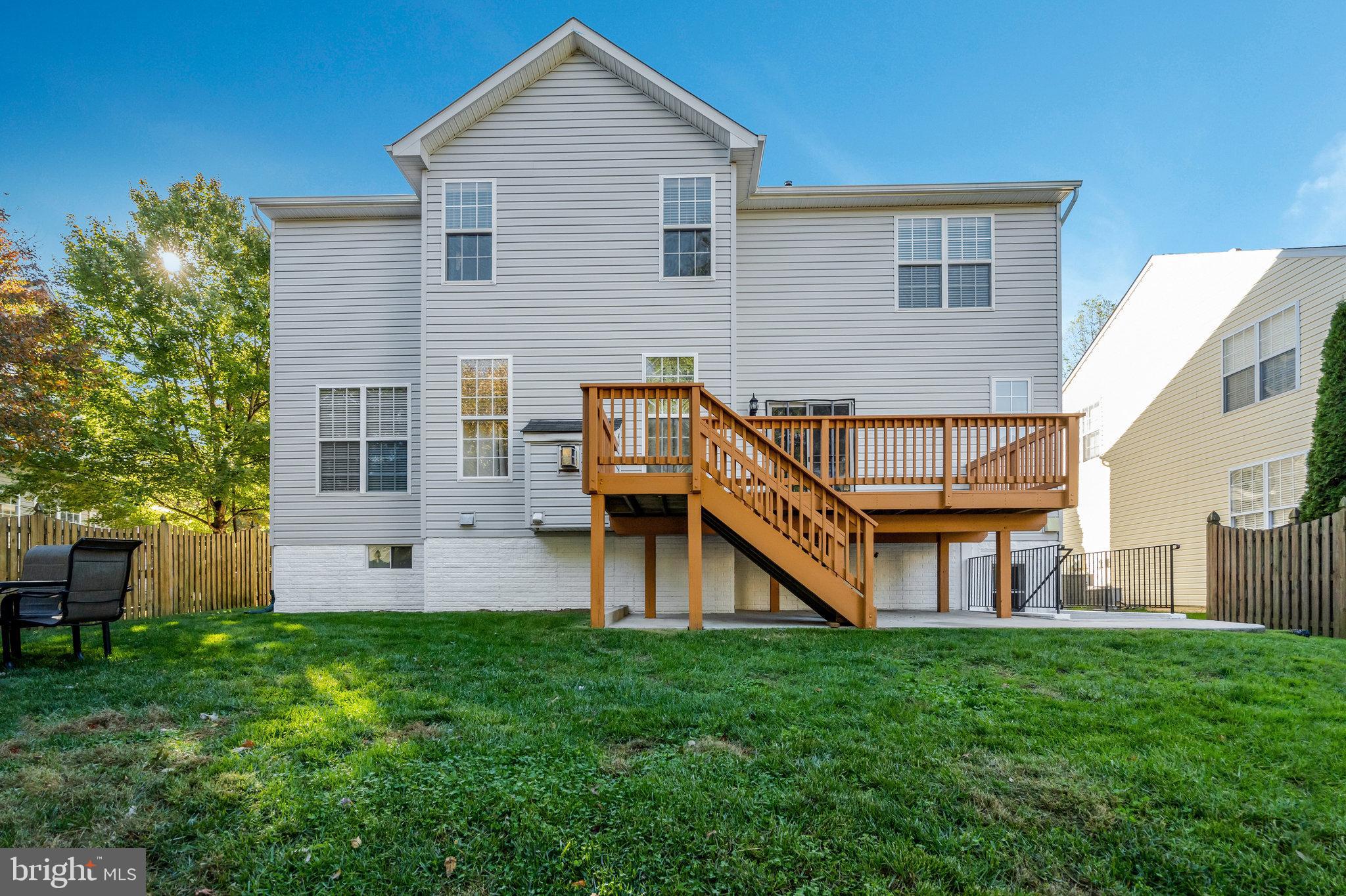 7726 Yalta Way Gainesville, VA 20155 - Photo 69 of 75 a view of a house with a backyard and a patio