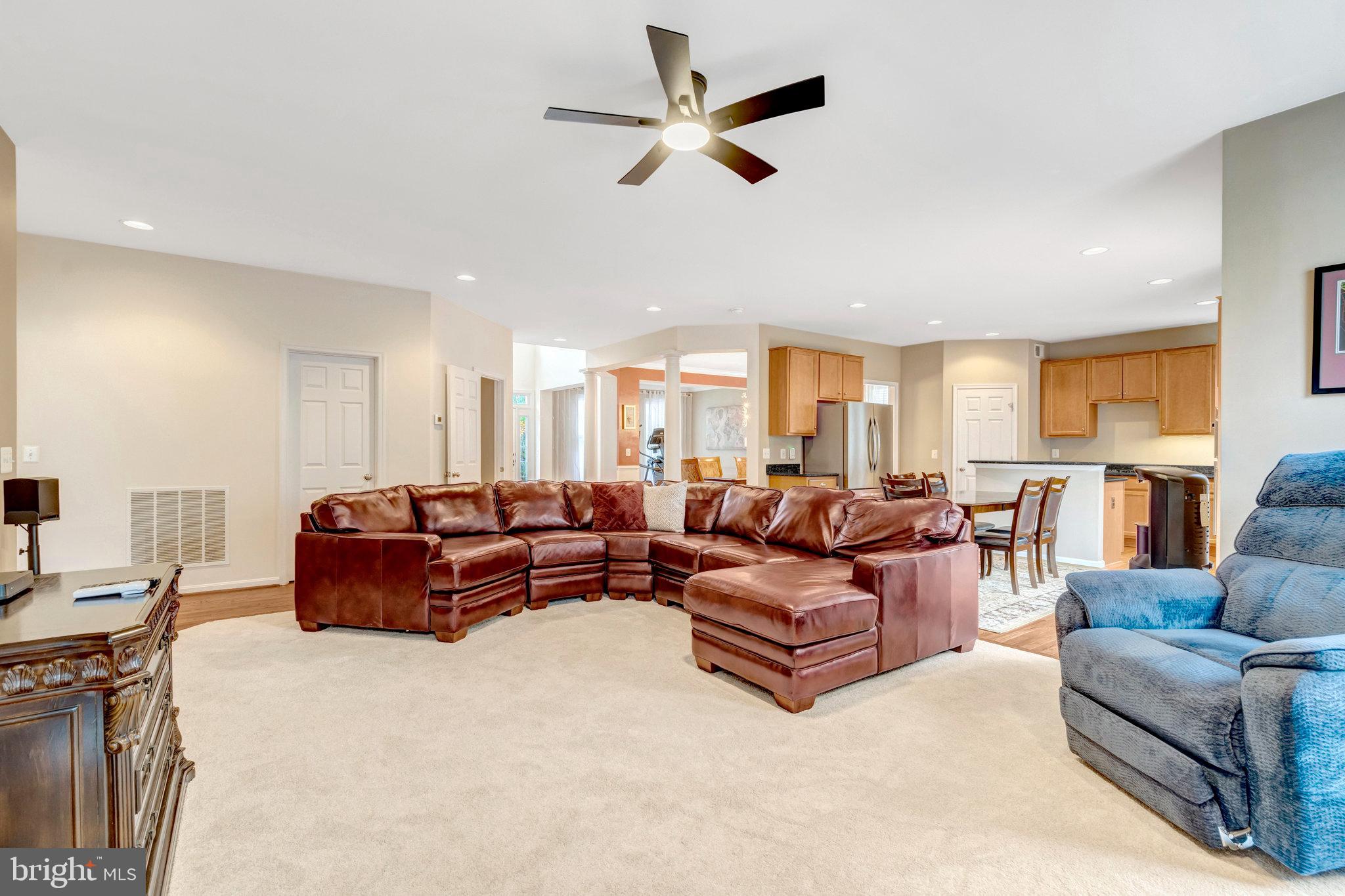 7726 Yalta Way Gainesville, VA 20155 - Photo 7 of 75 a living room with furniture ceiling fan and a rug