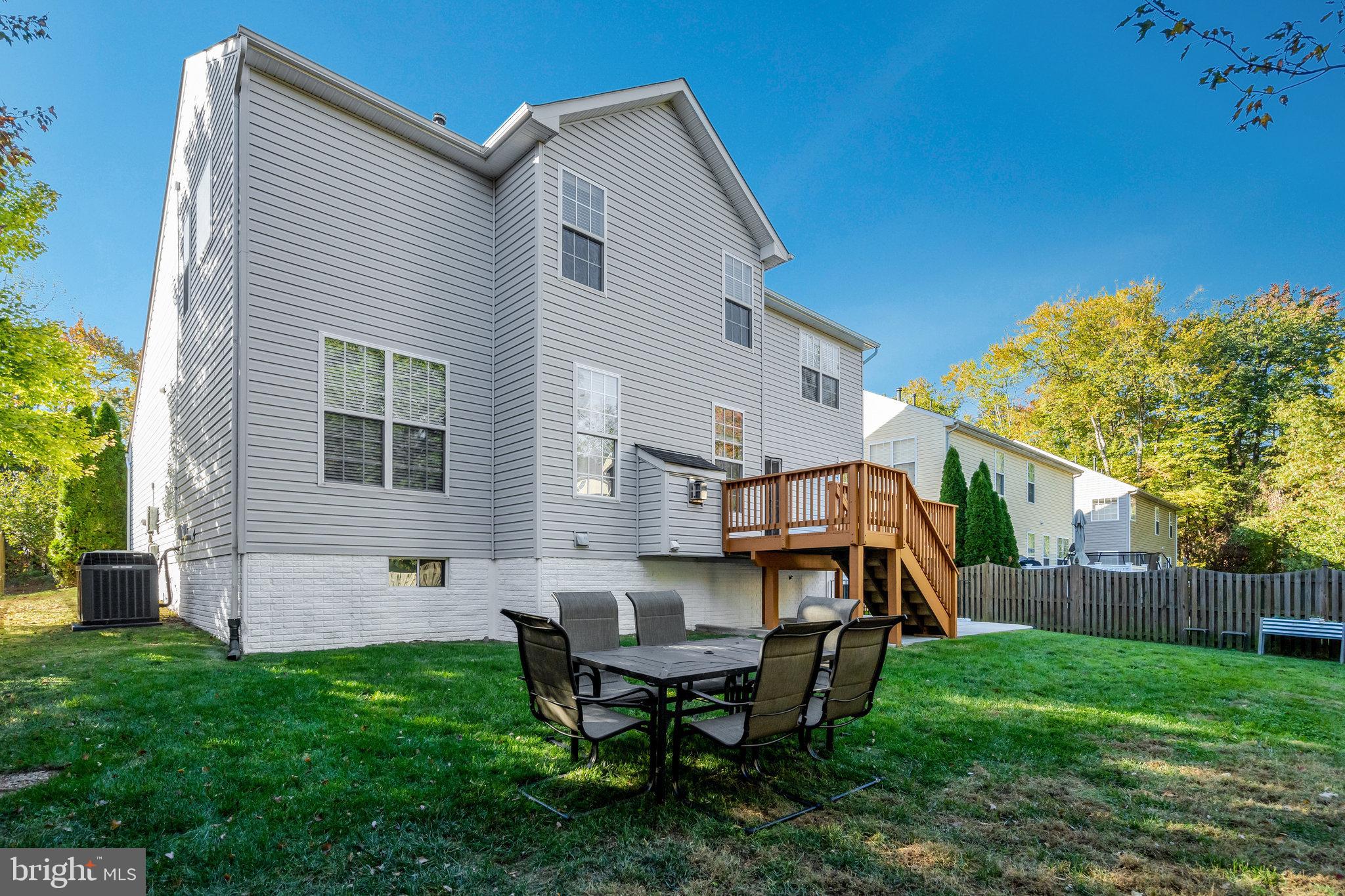 7726 Yalta Way Gainesville, VA 20155 - Photo 72 of 75 a view of a house with backyard and a small cabin