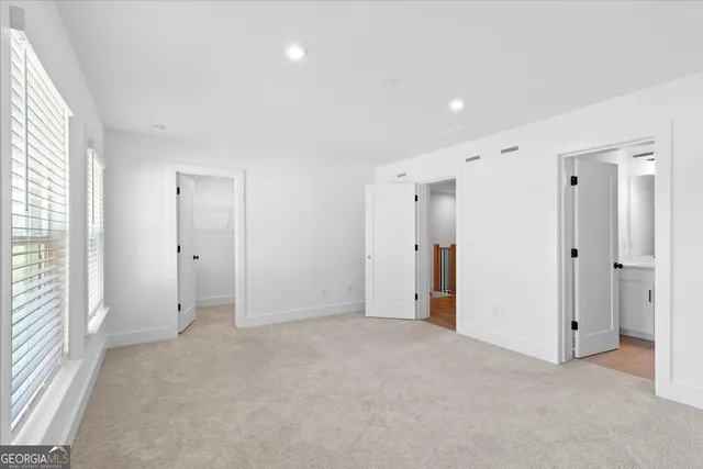 an empty room with closet and a window
