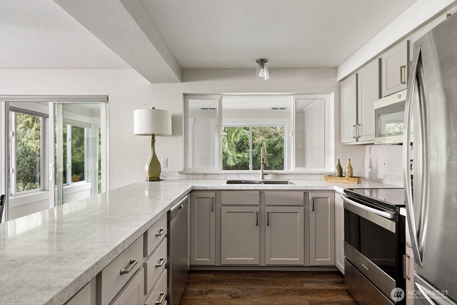 566 Creekside Terrace, Unit 101 Langley, WA 98260 - Photo 1 of 31 a kitchen with a sink stove and cabinets
