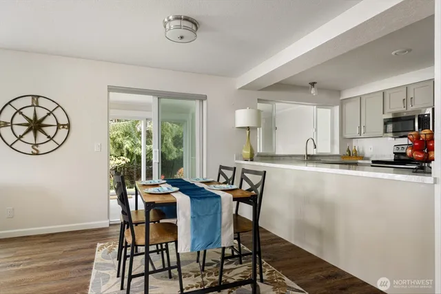 a view of a dining room with furniture window and wooden floor